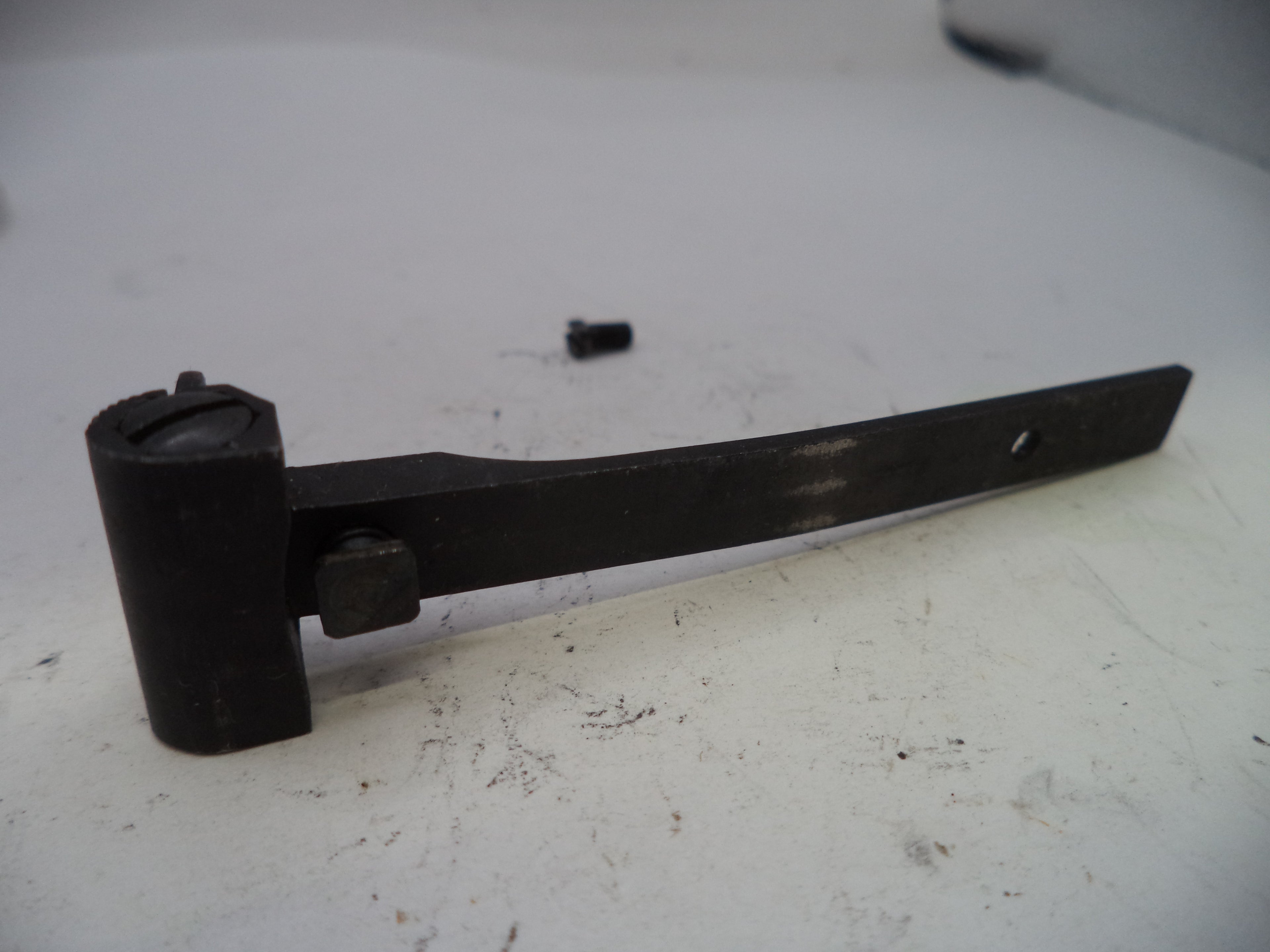 Black metal bracket on a white surface