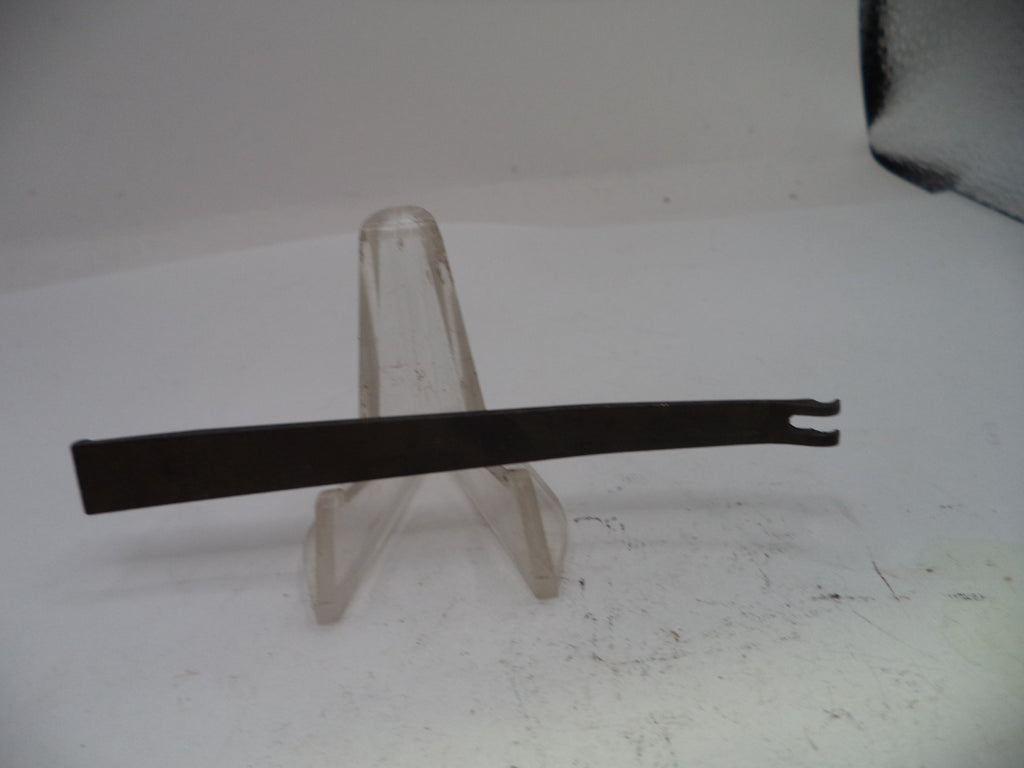 Black metal tool on a clear stand against a white background