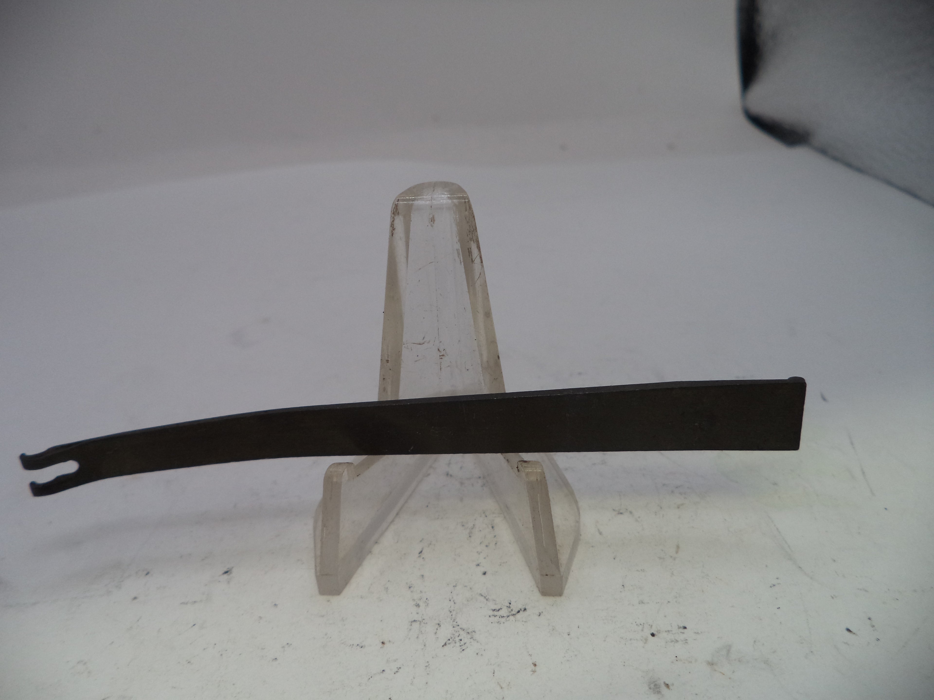 Metal tool on a stand against a white background