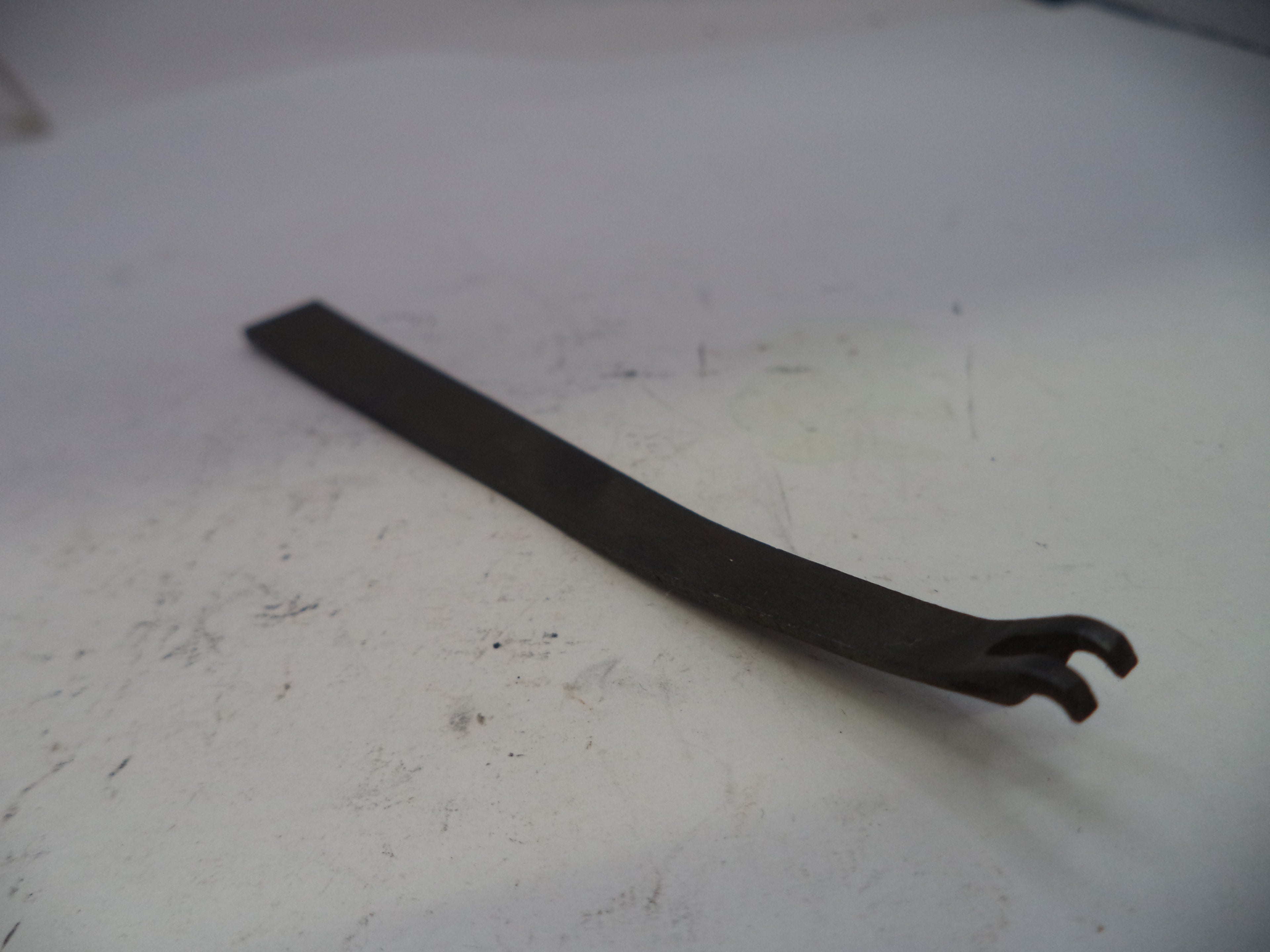 Metal tool on a white surface