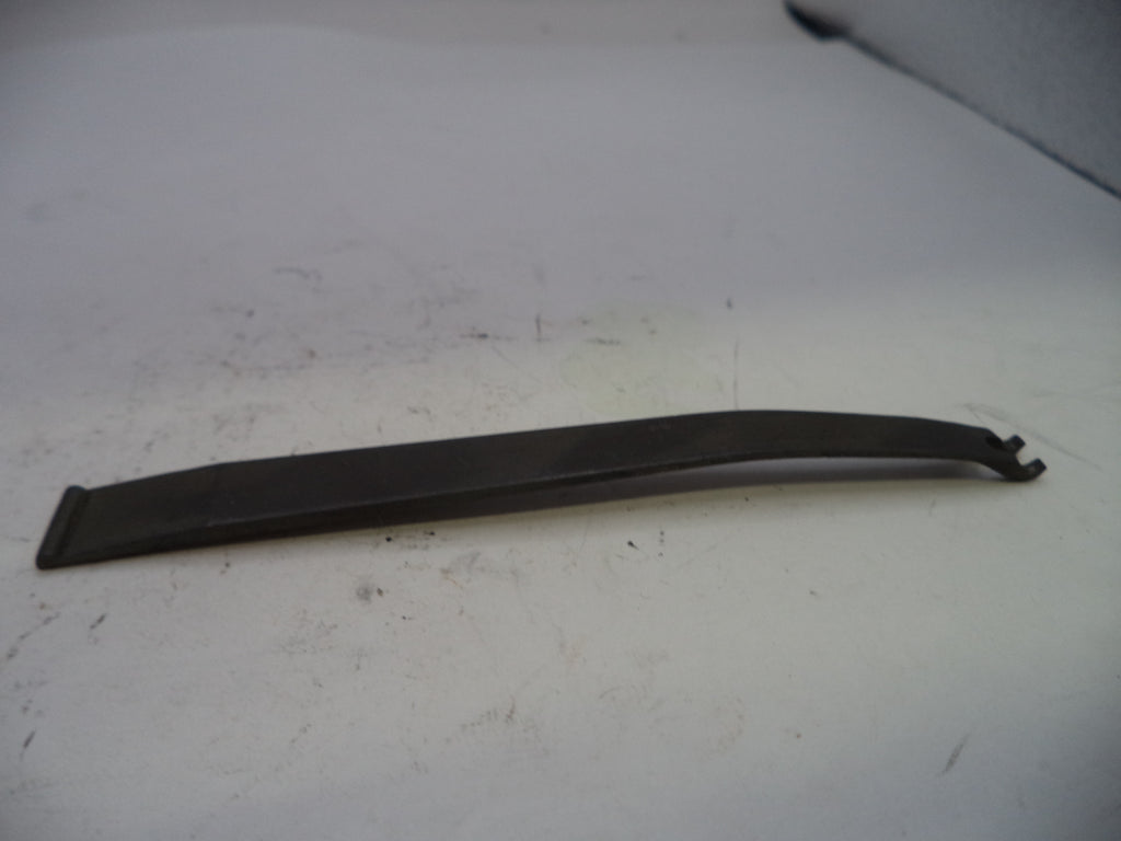 Black plastic trim piece on a white surface