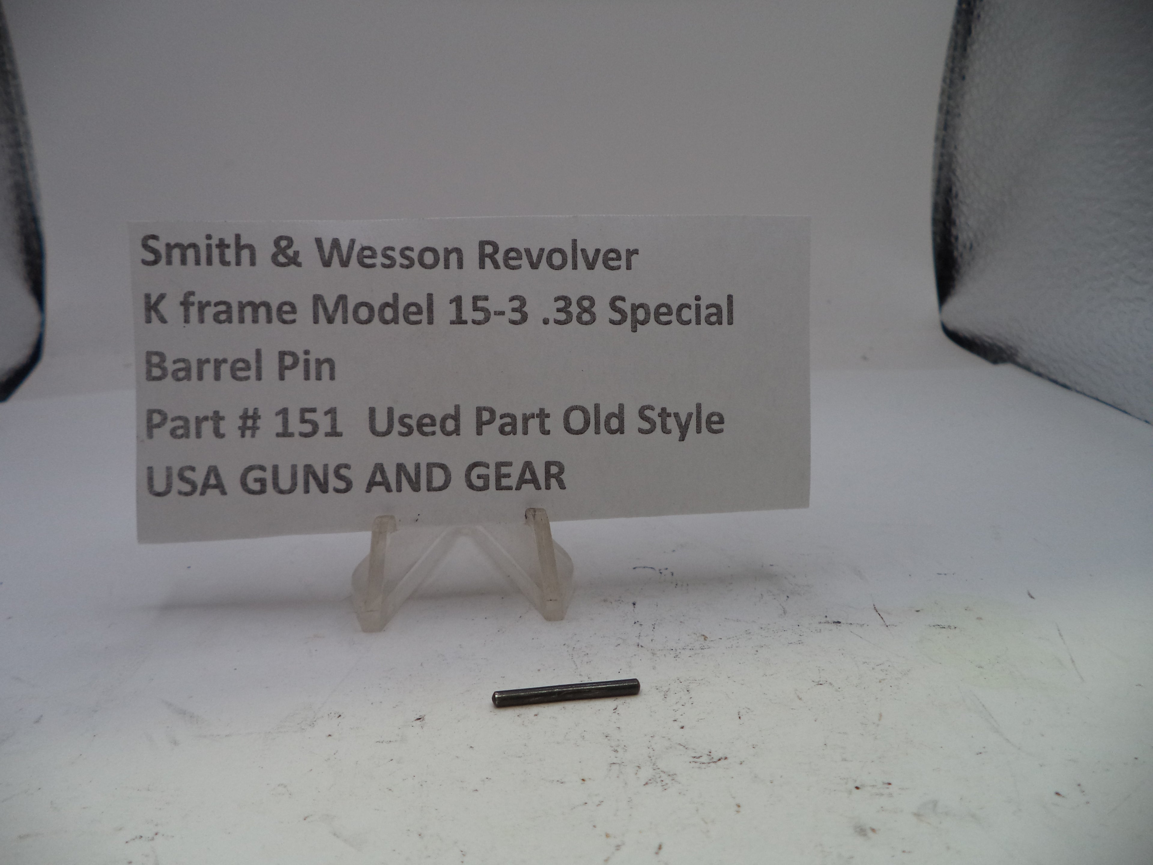 Smith & Wesson revolver barrel pin with a label on a white background