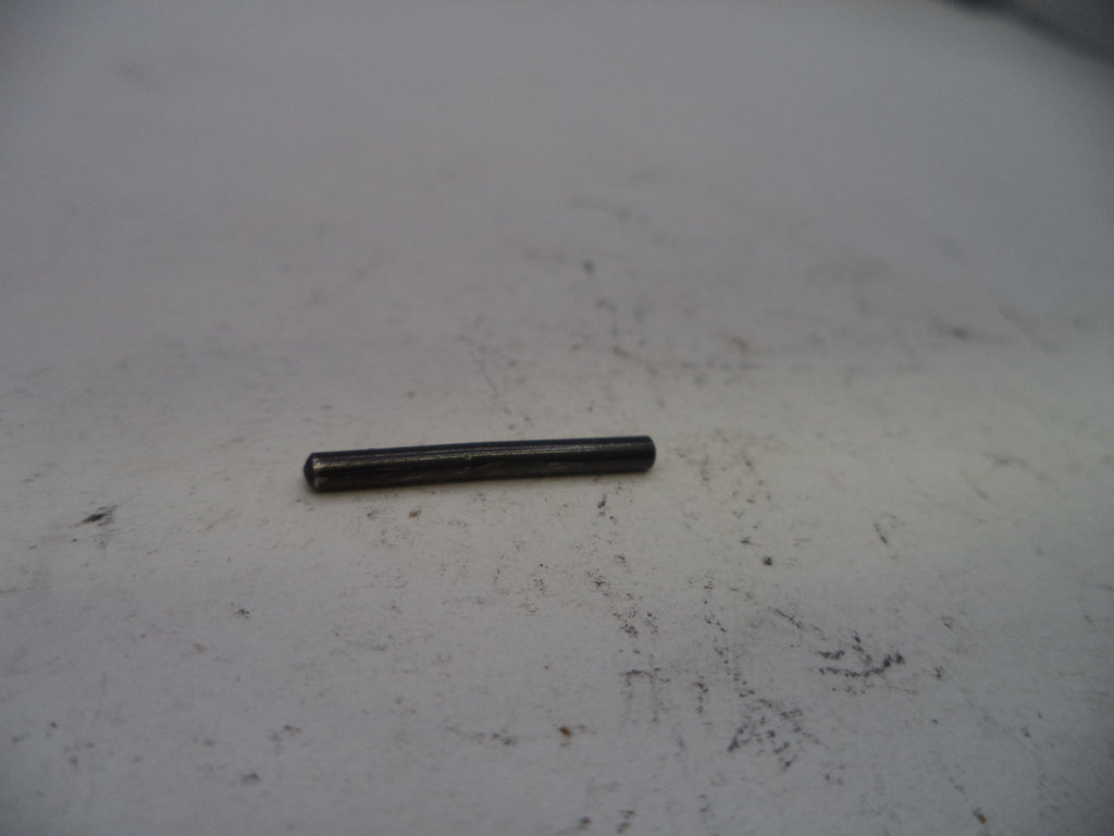 Small black cylindrical object on a white surface