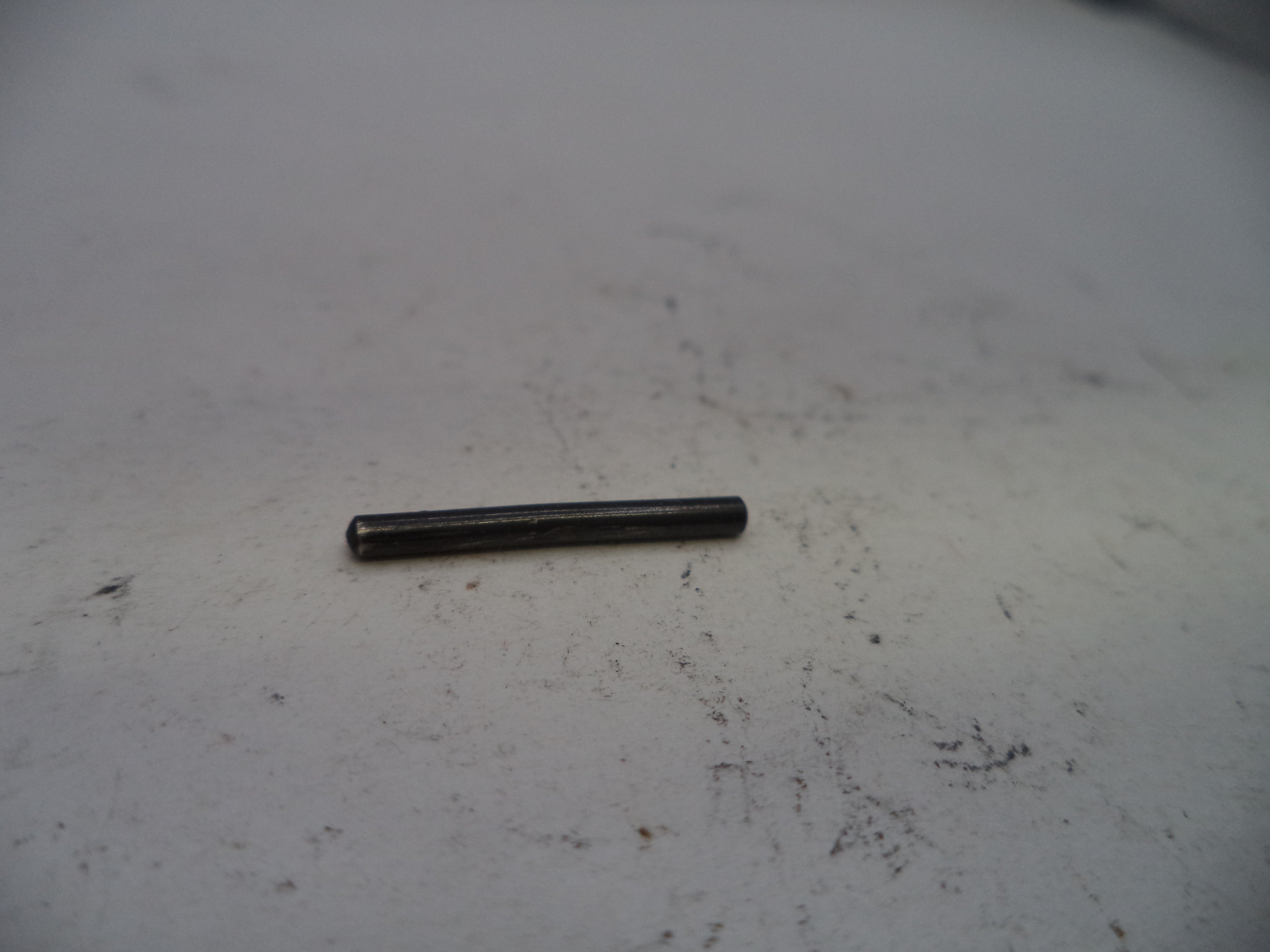 Small black cylindrical object on a white surface