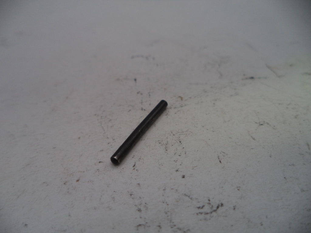 Small black cylindrical object on a white surface with visible dirt and stains.