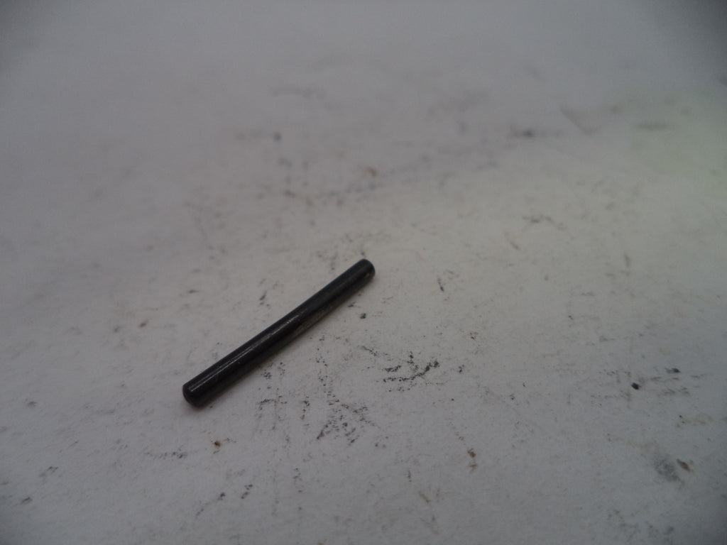 Black cylindrical object on a textured white surface