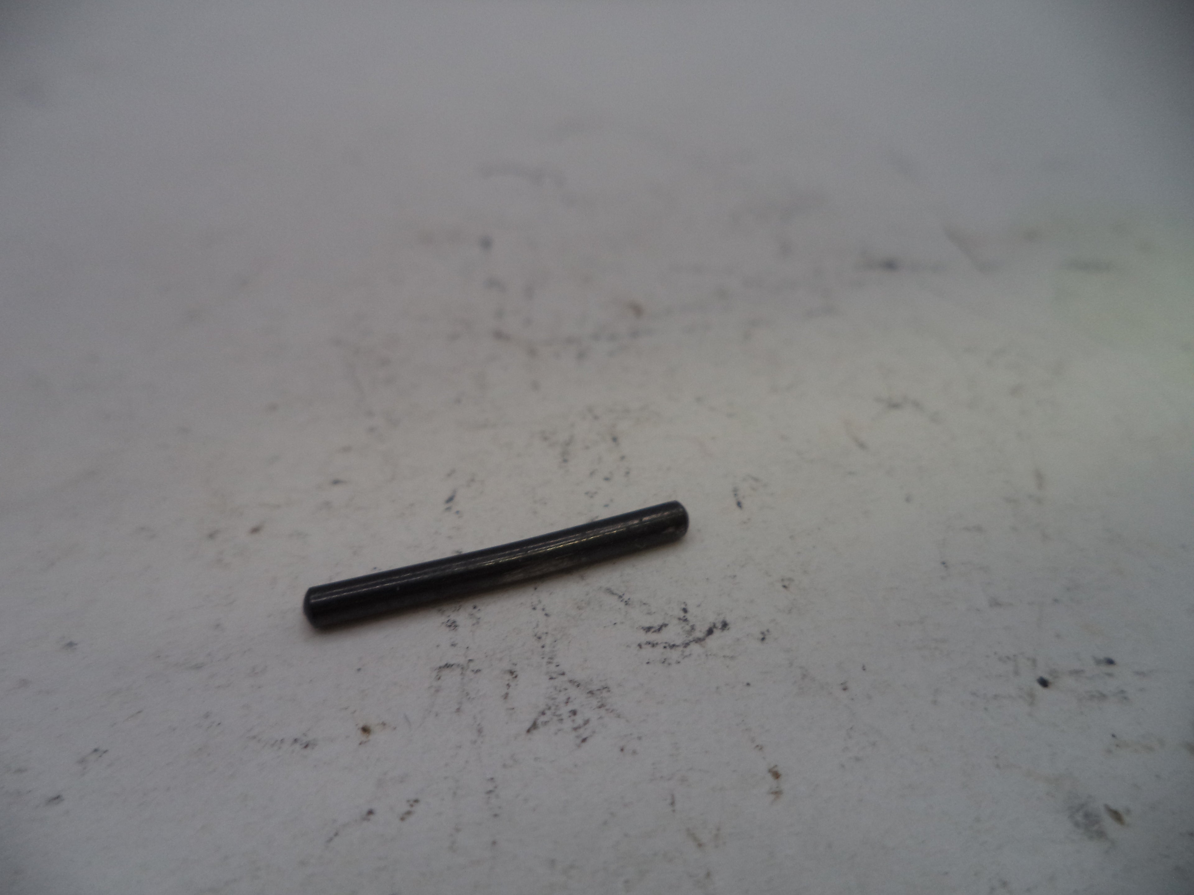 Black cylindrical object on a white surface