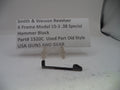 Smith & Wesson revolver hammer block part on a white background with a label.