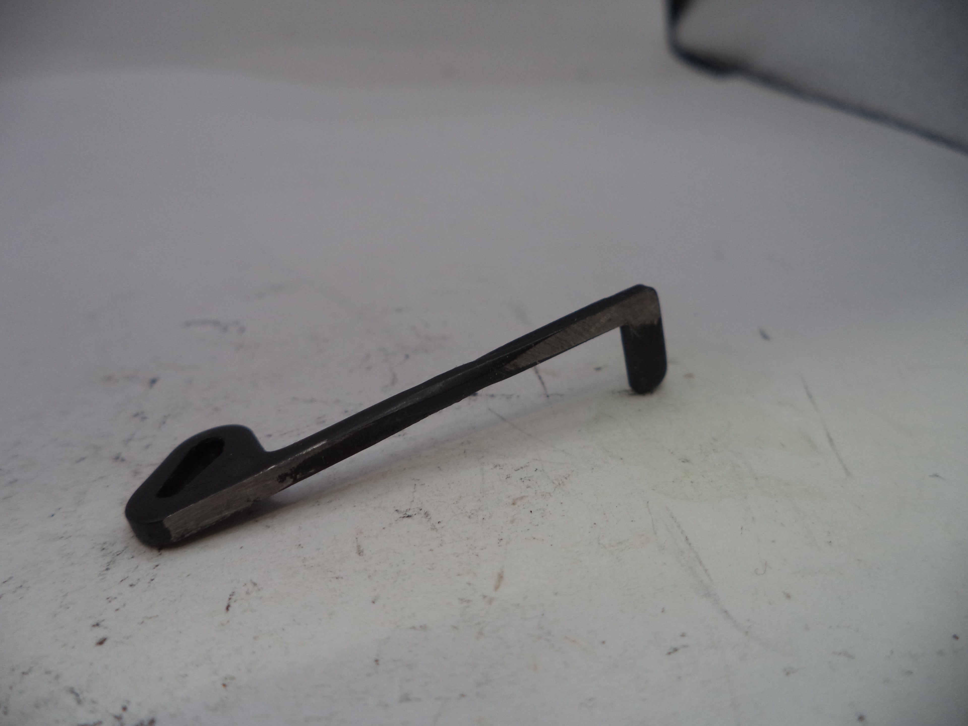 Metallic tool on a white surface