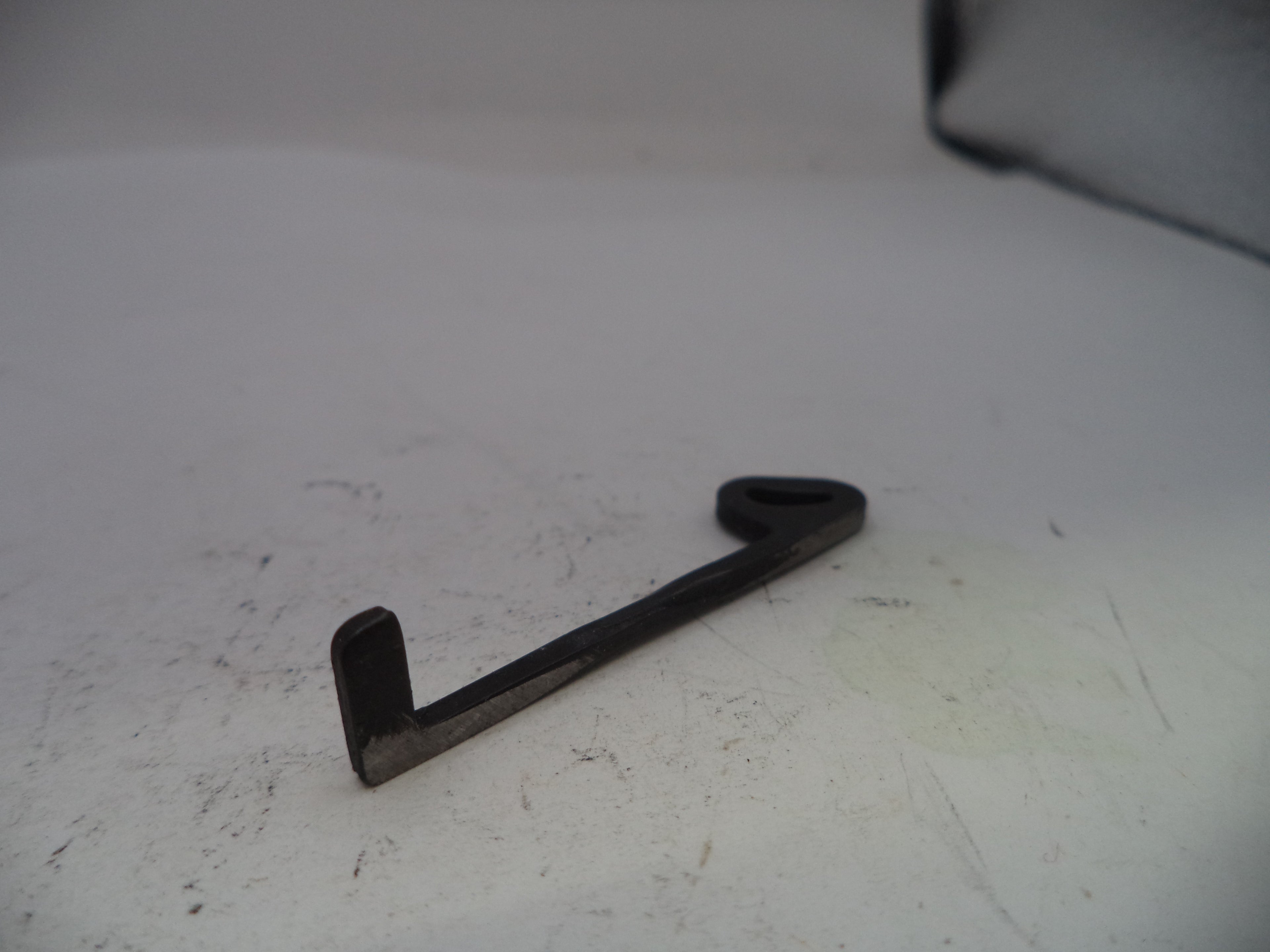 Metal bracket on a white surface