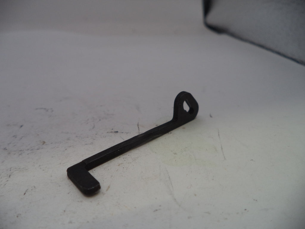 Black metal wrench on a white surface
