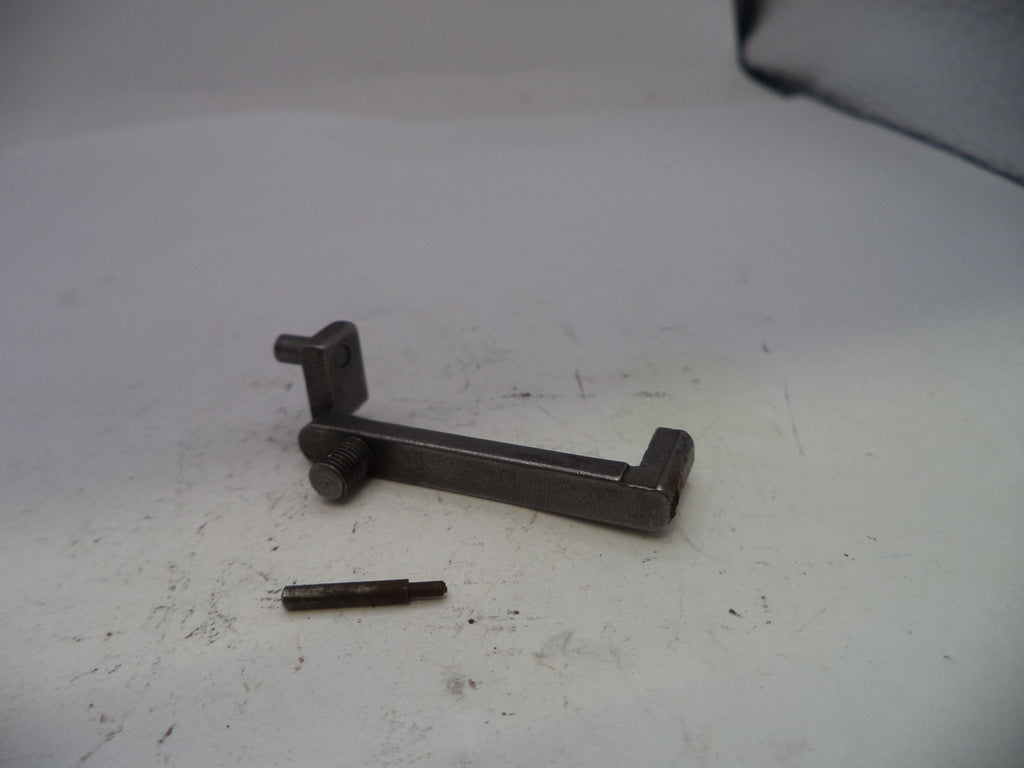 Metal bracket and screw on a white surface