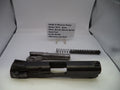Smith & Wesson pistol parts including slide, barrel, and recoil spring on a white surface with a label.