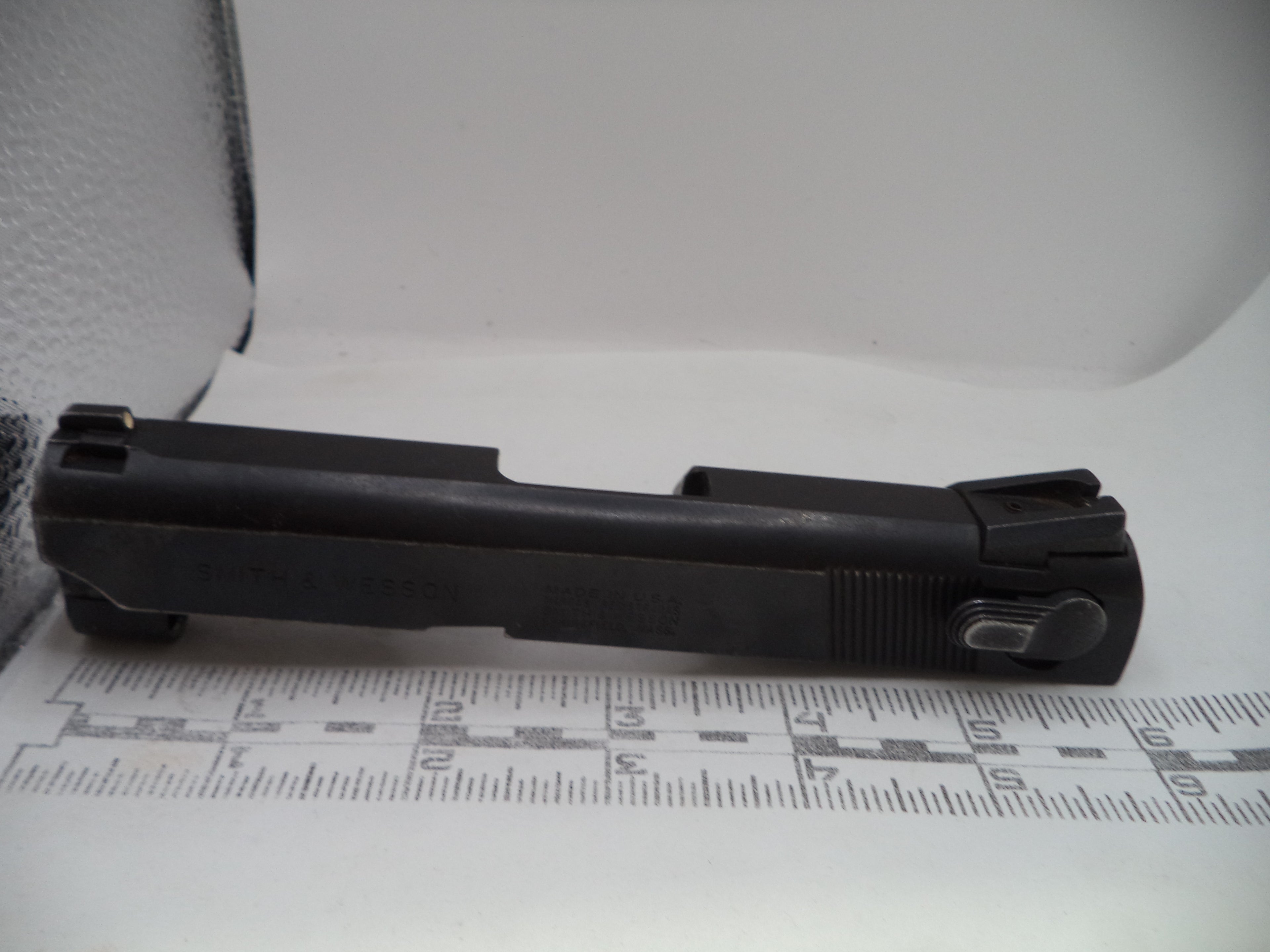 Black gun stock on a white surface with measurement chart