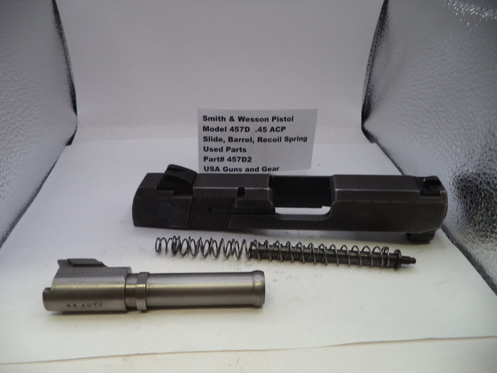 Smith & Wesson pistol parts including slide, barrel, and recoil spring on a white background with branding.