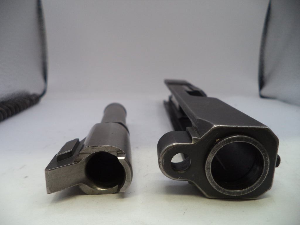 Two metal components on a white surface with a neutral background