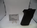 Black gun grip with a label on a white background