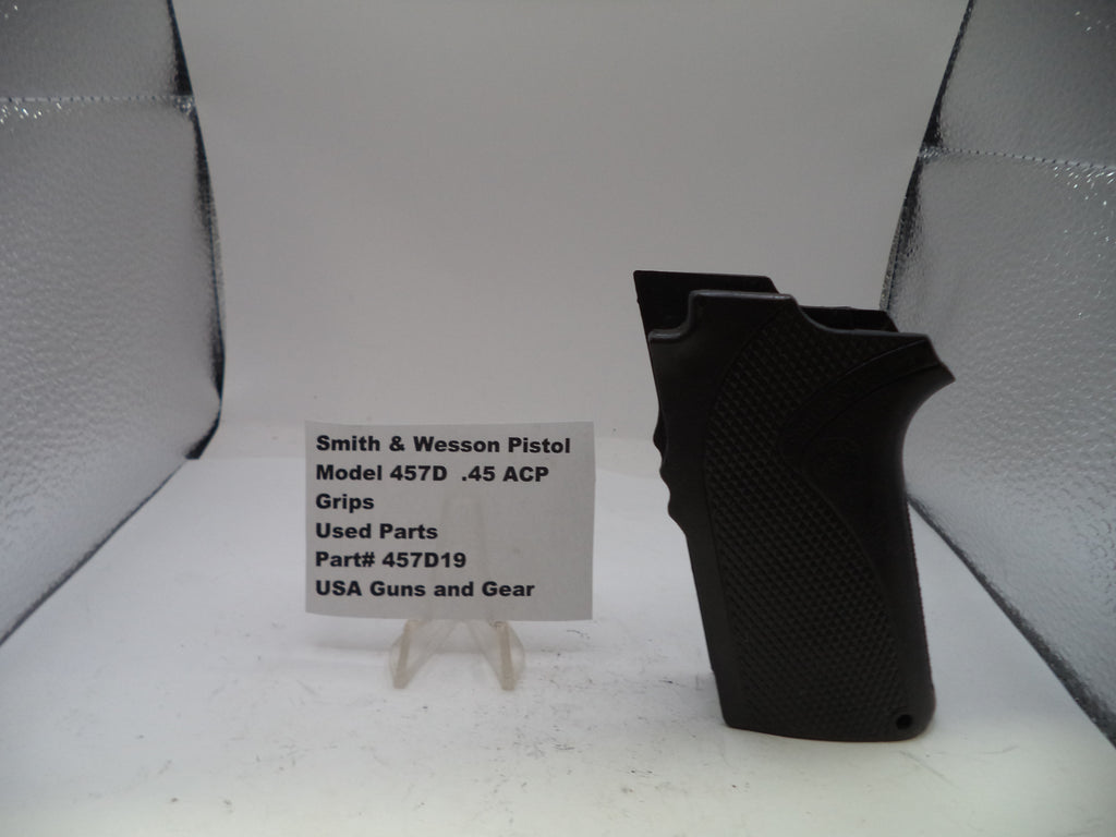 Black pistol grip on a stand with a label in front of a gray background