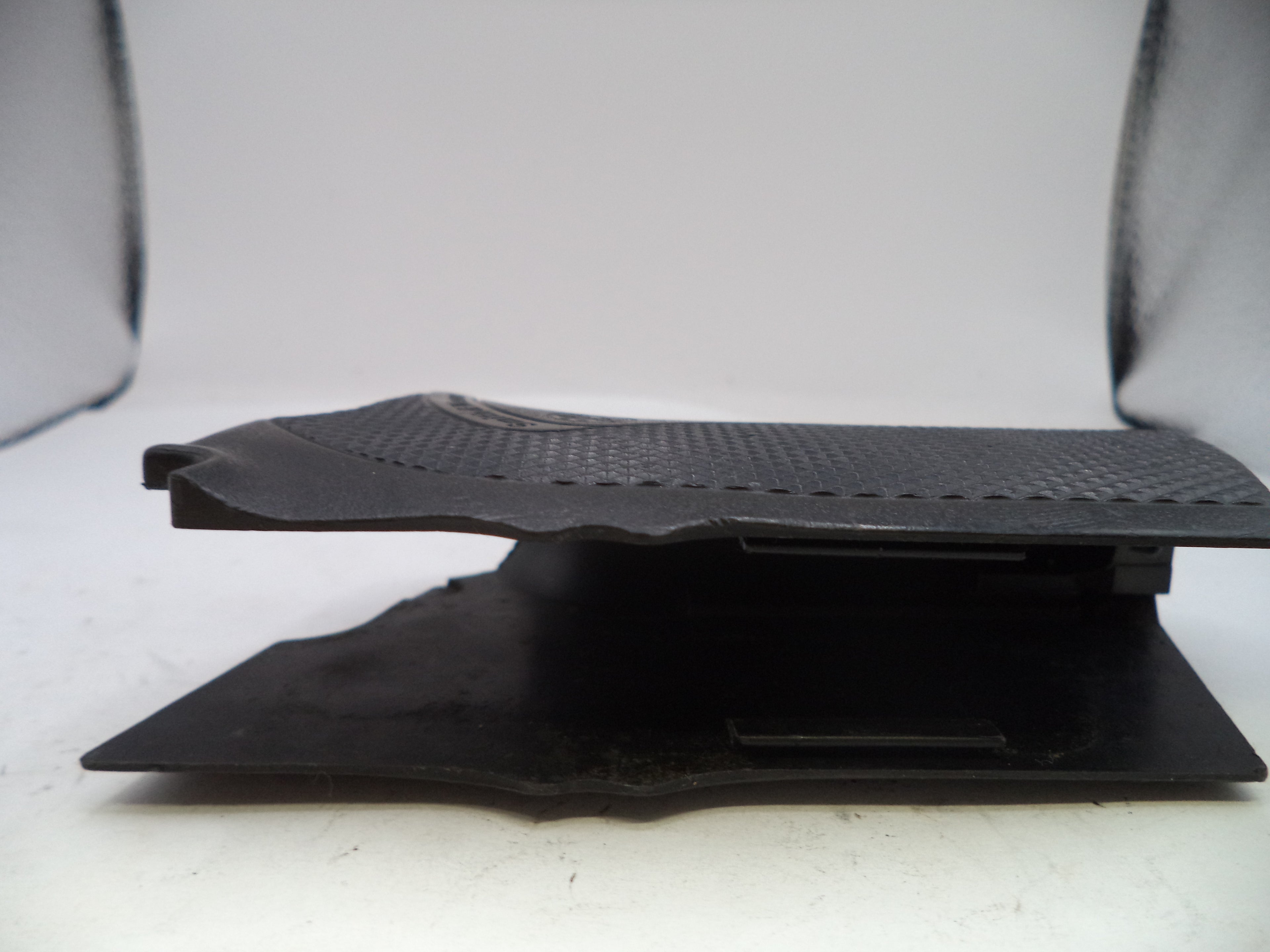 Black textured object on a white background