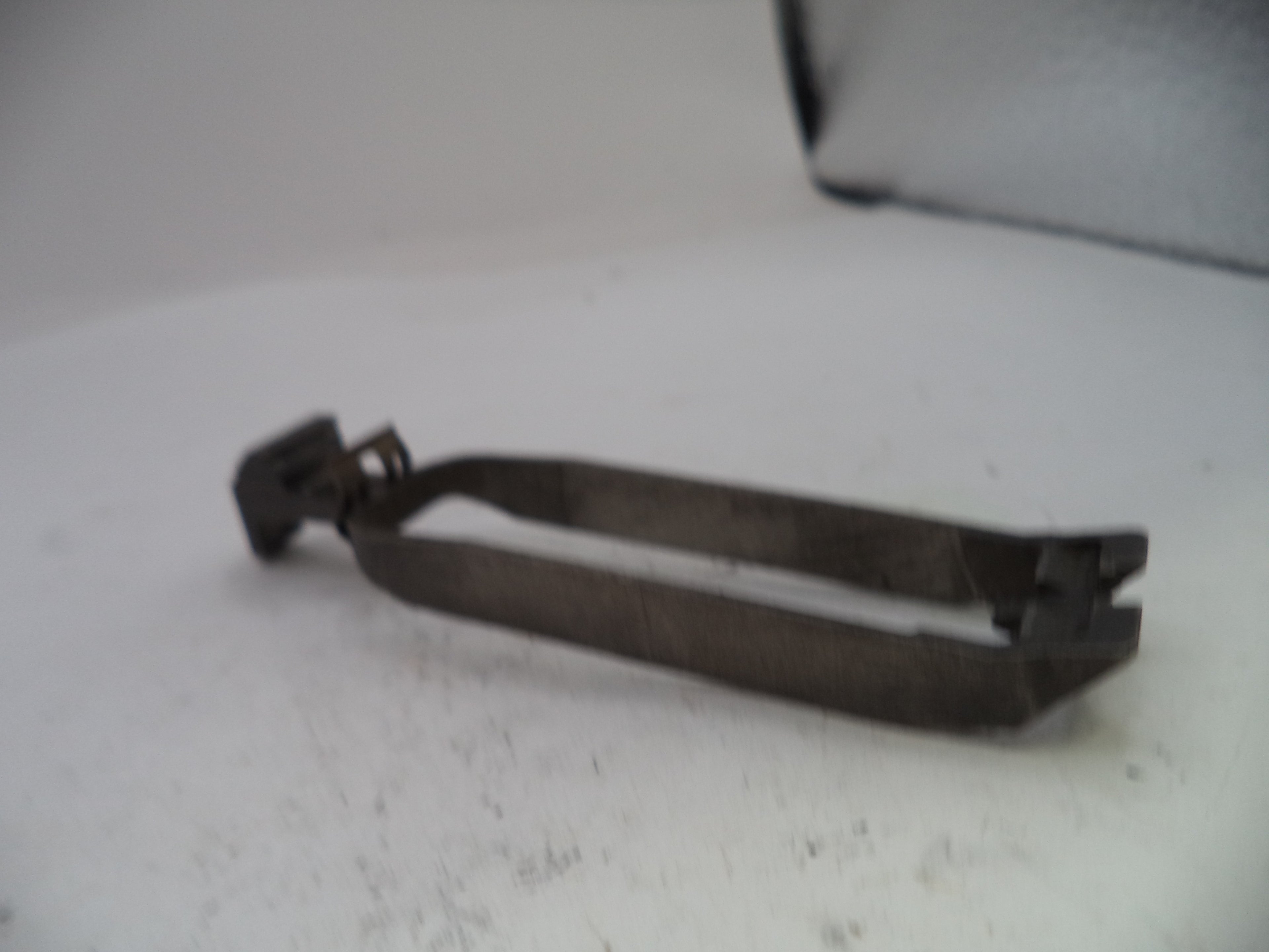 Metallic tool on a white surface