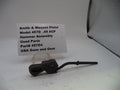 Smith & Wesson pistol hammer assembly on a white surface with a label.