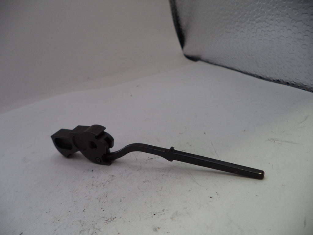 Black metal lever on a white surface with a textured gray background