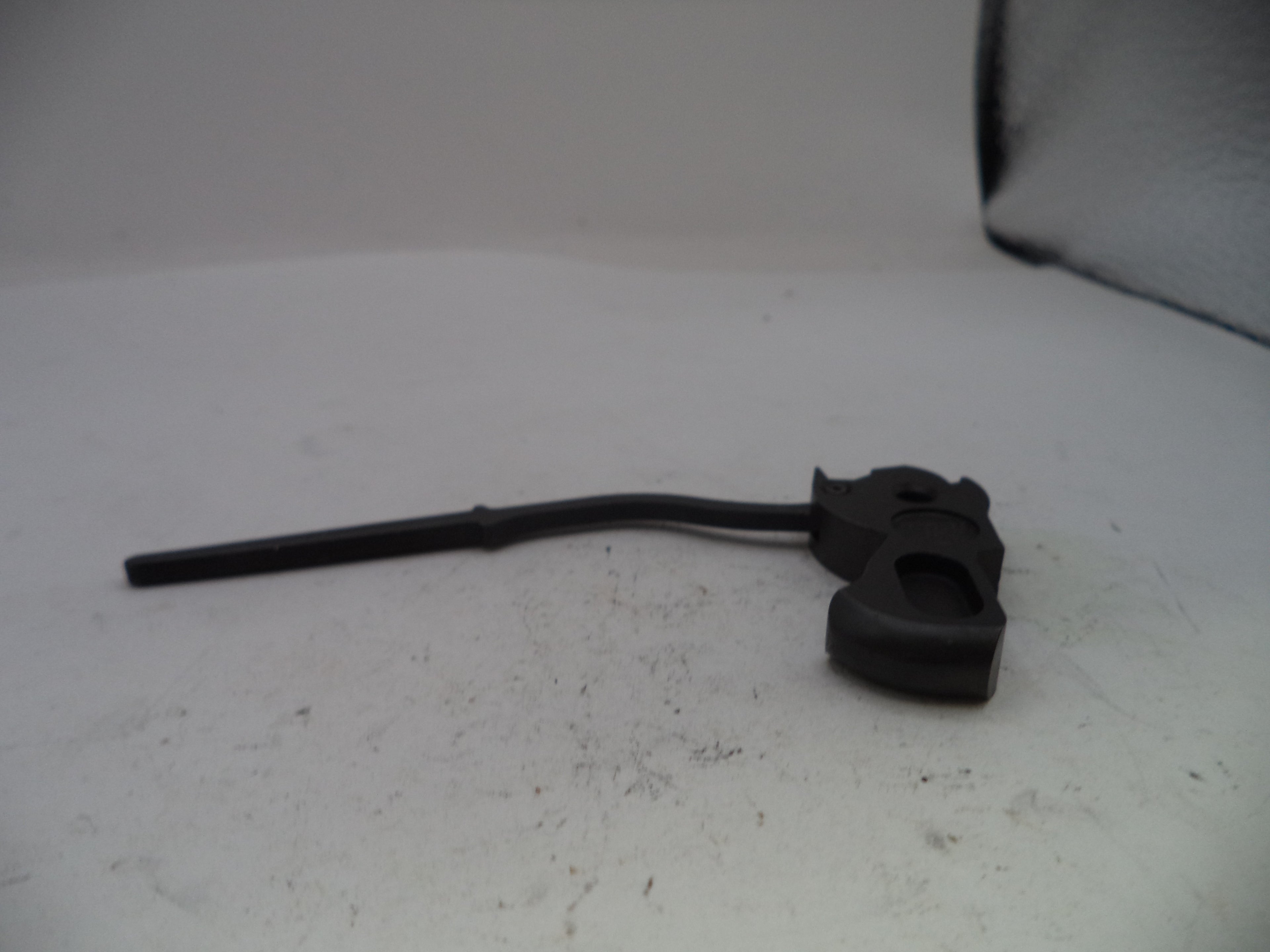 Black metal component on a white surface