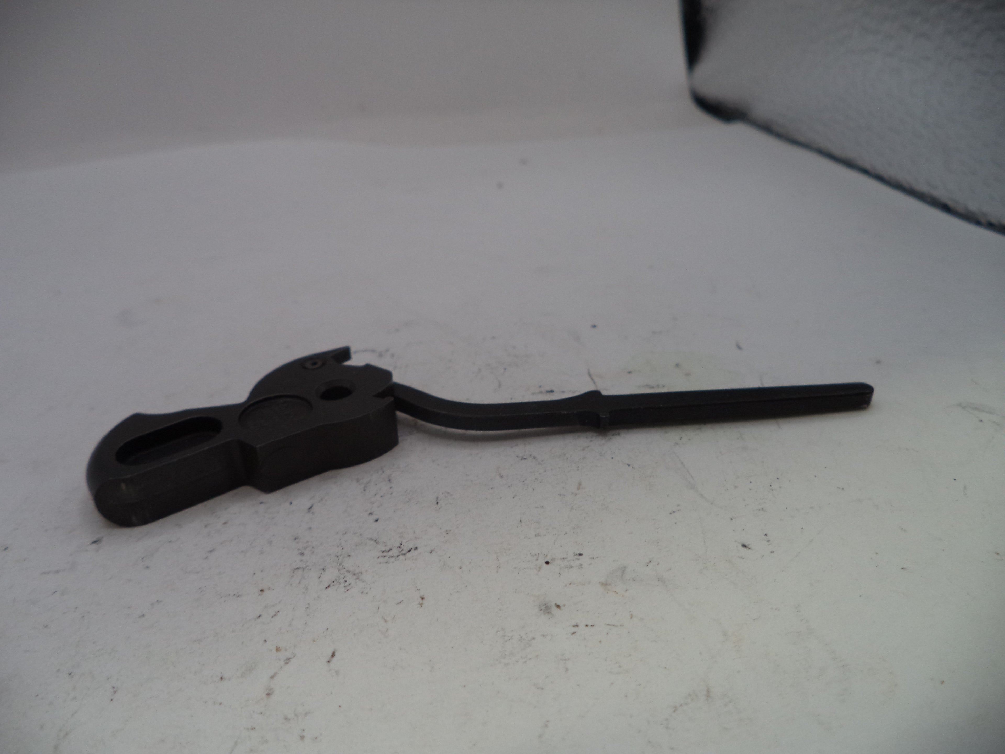 Black metal tool on a white surface