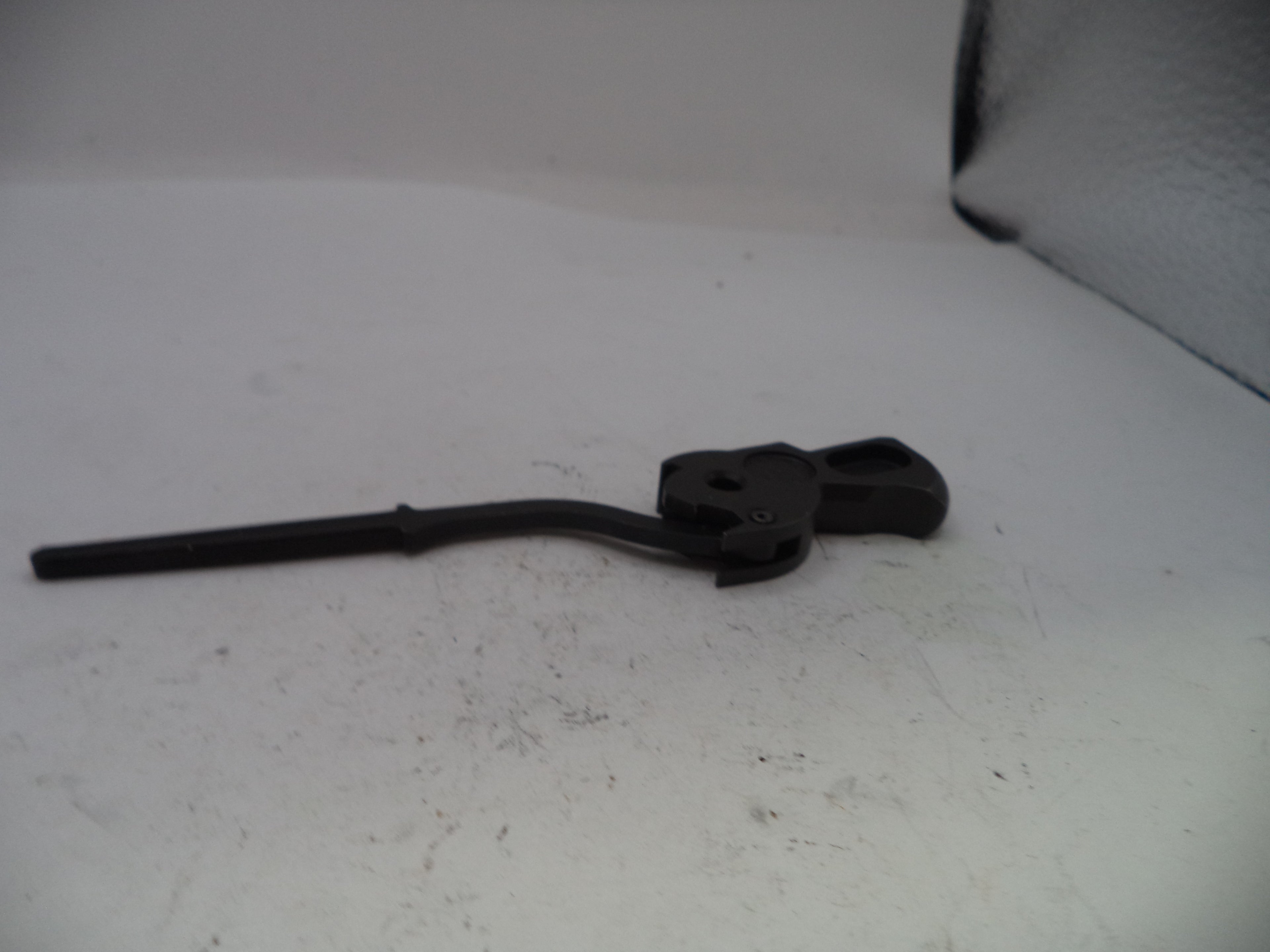 Black metal lever on a white surface