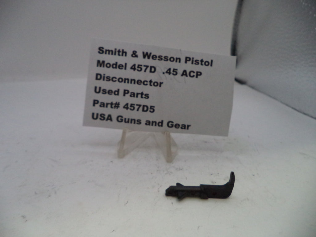 Used parts of a Smith & Wesson Pistol Model 457D .45 ACP Disconnector on a white background with a label.