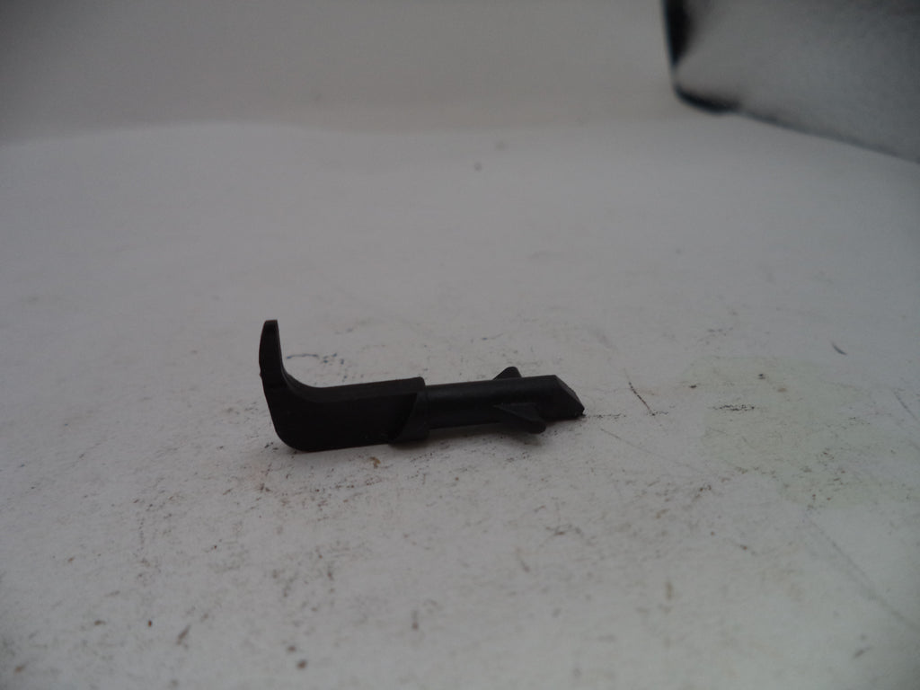 Black plastic component on a white surface