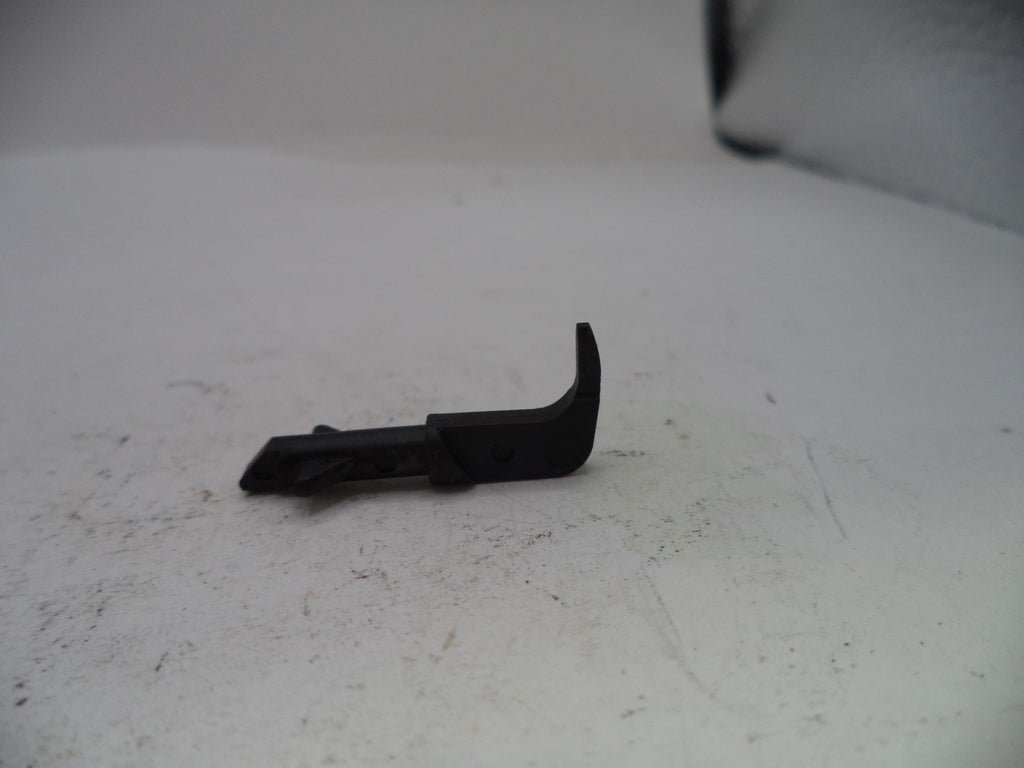 Black plastic component on a white surface