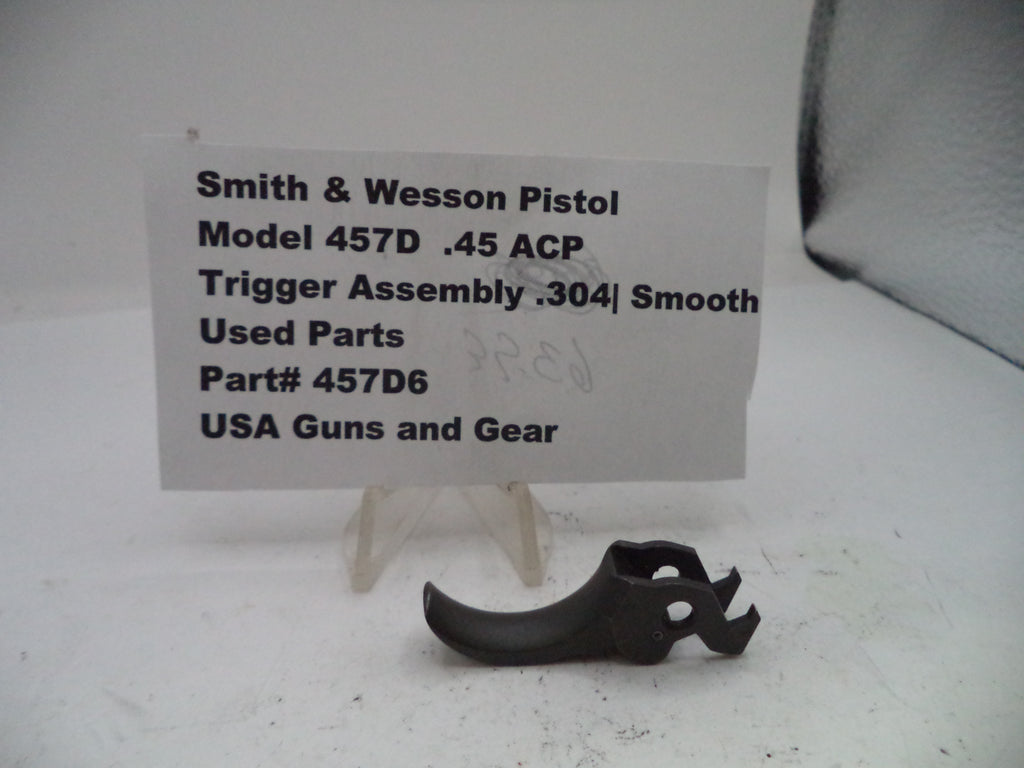 Smith & Wesson pistol trigger assembly on a white background with a label.
