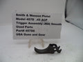 Smith & Wesson pistol trigger assembly on a white background with a label.