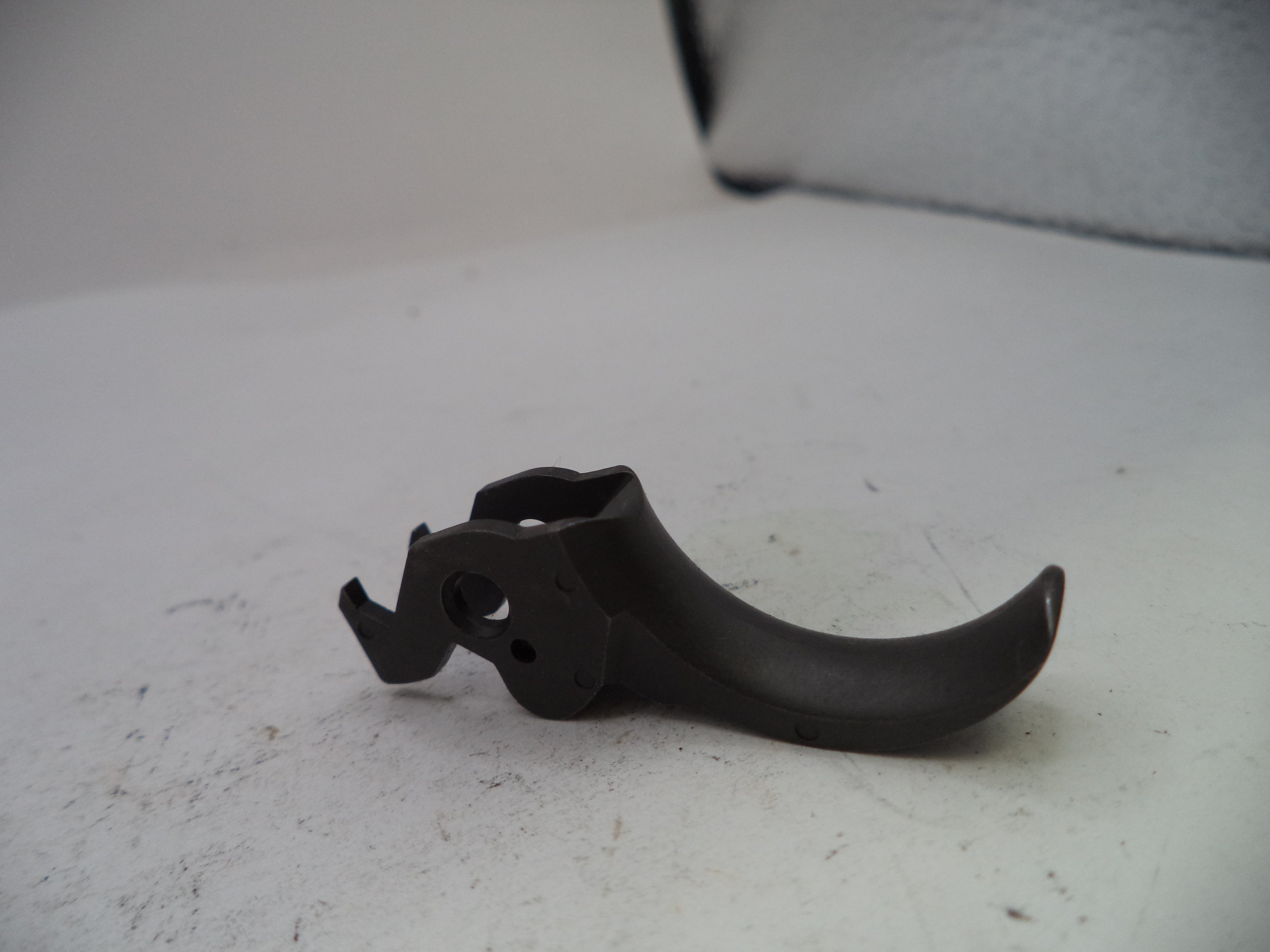 Black metal component on a white surface