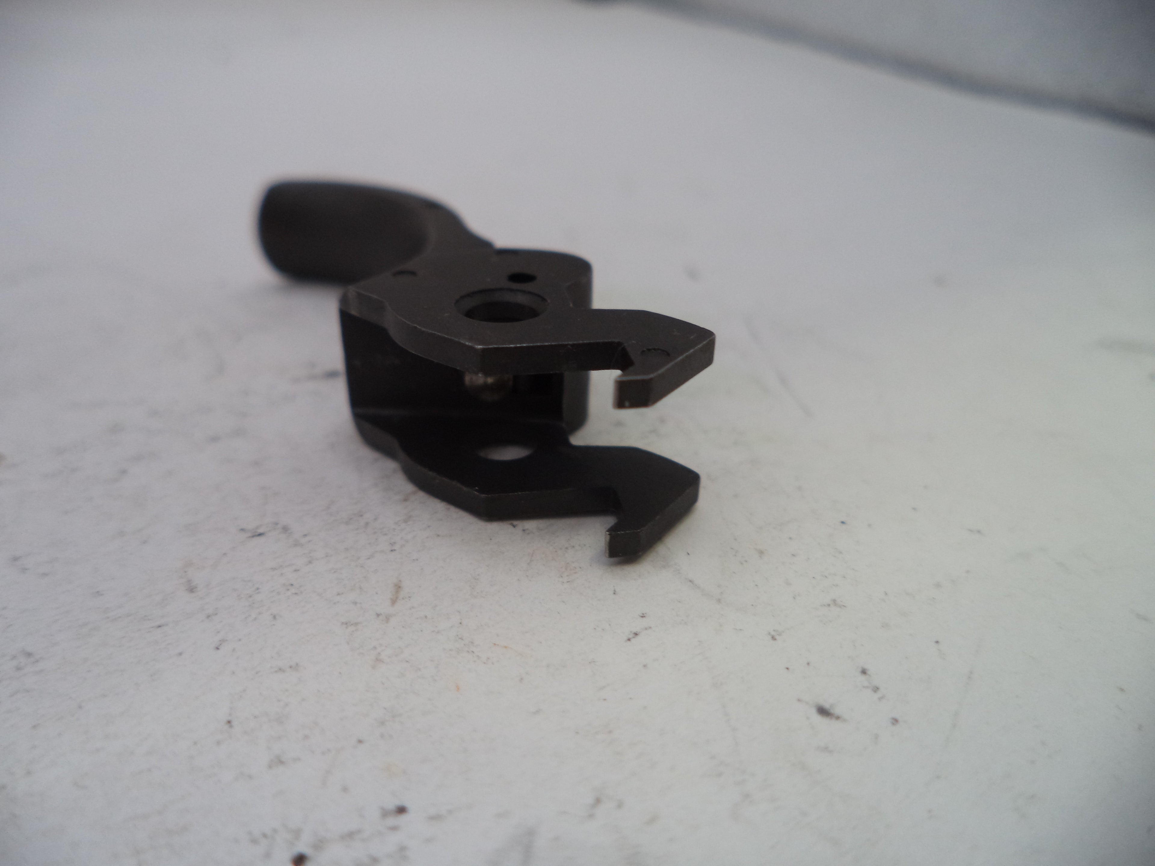 Black metal clip on a white surface