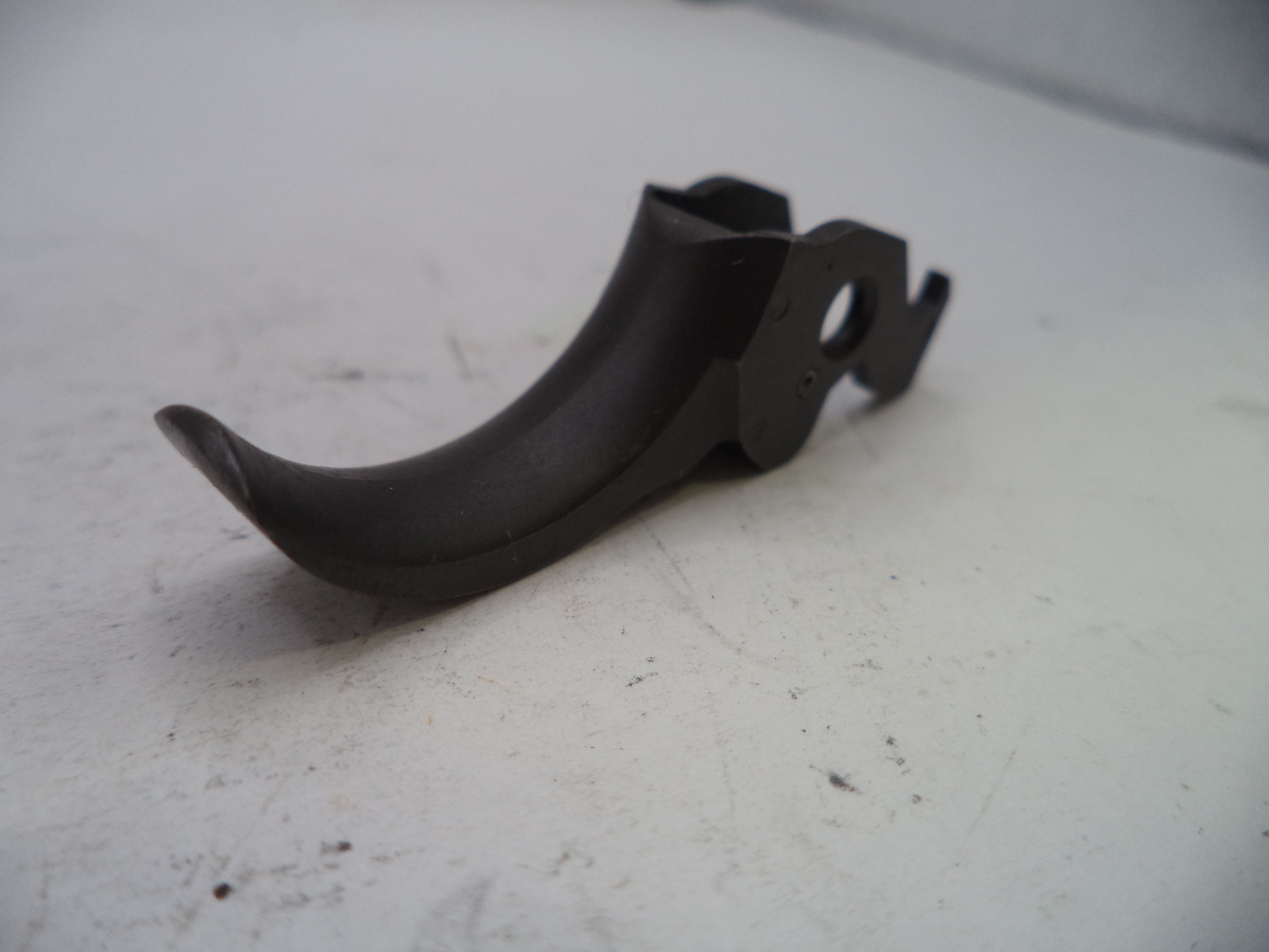 Black plastic component on a light gray surface