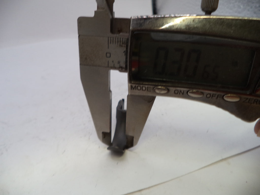 Digital caliper measuring a small object on a white background