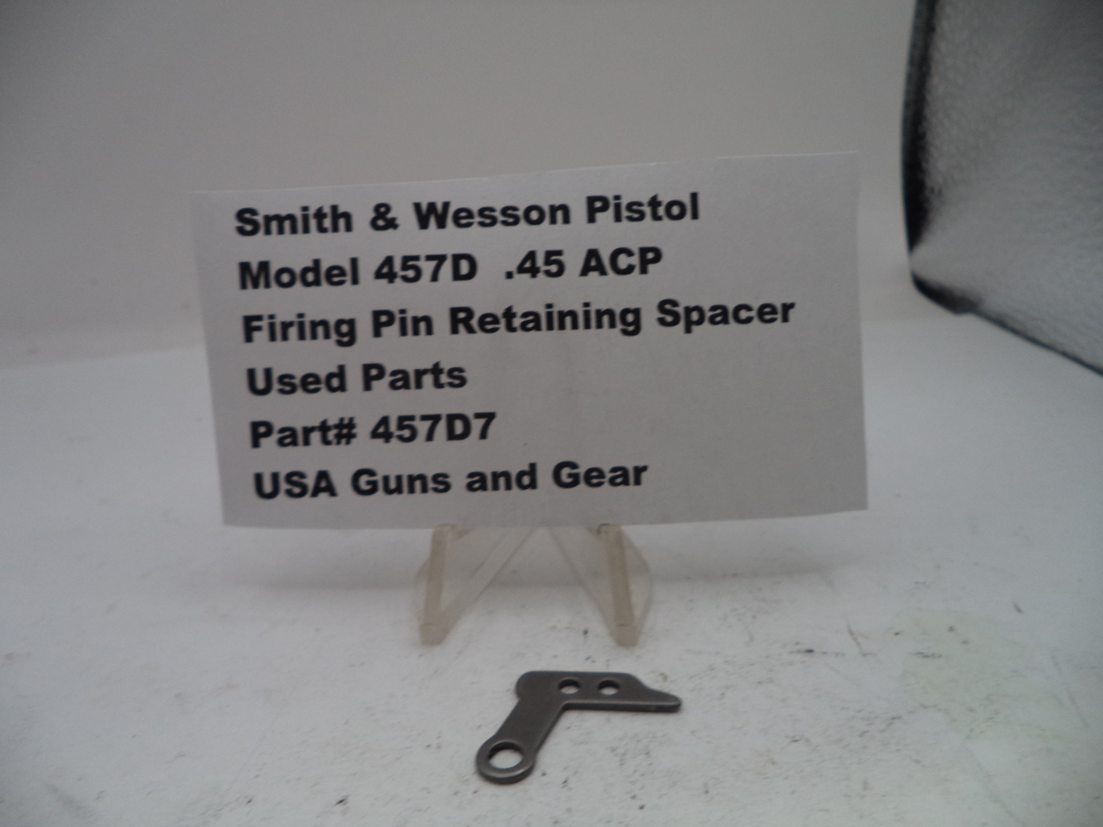 Firing pin retaining spacer for Smith & Wesson Pistol Model 457D .45 ACP on a white background with a label.