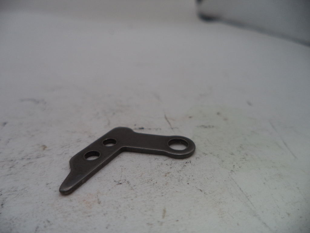 Metal bracket on a worn white surface
