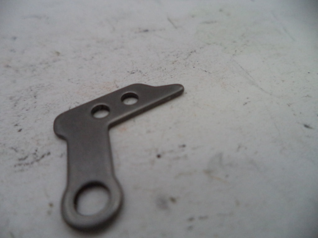 Metallic tool with three holes on a textured surface