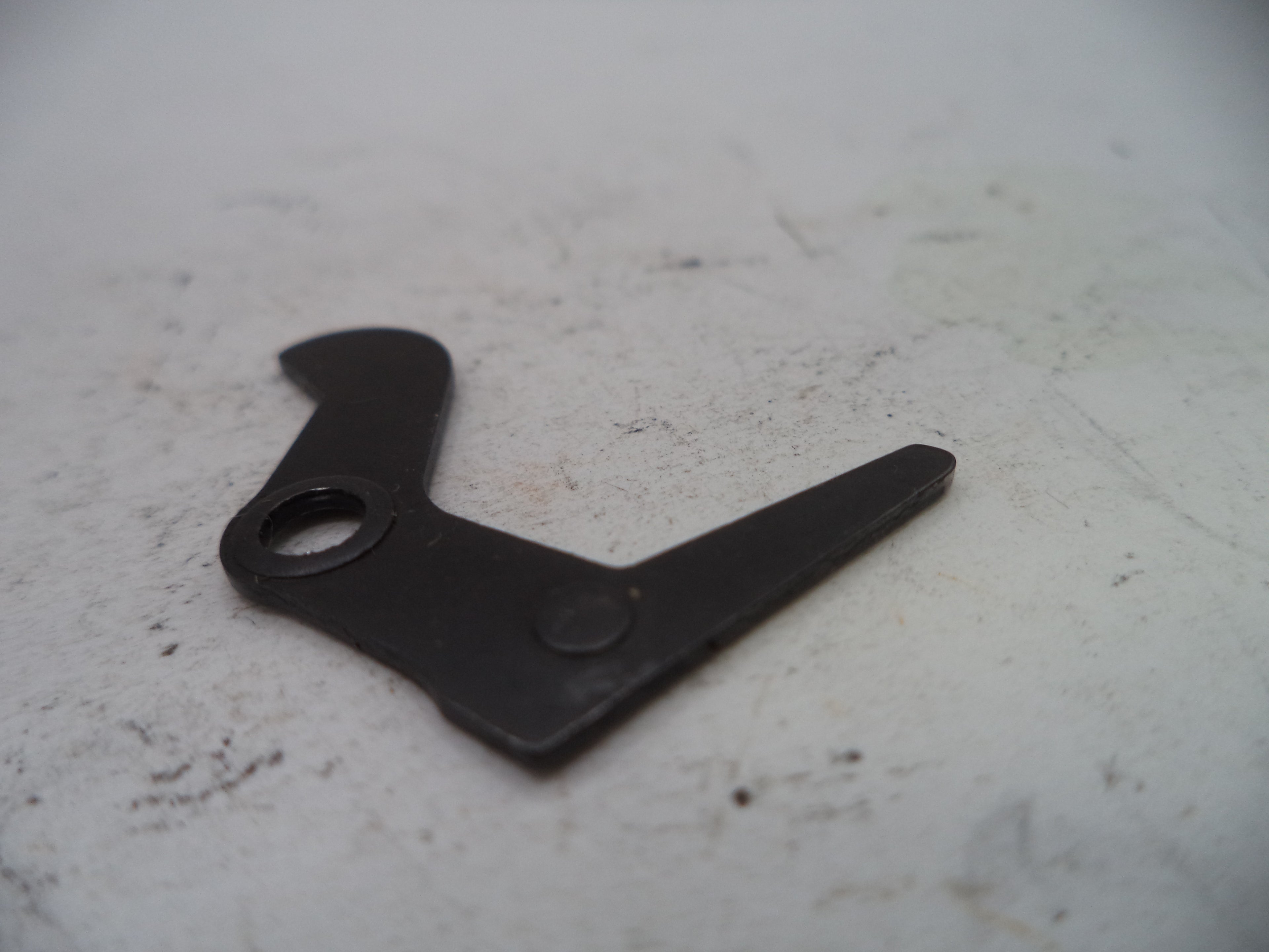 Black metal tool on a white surface