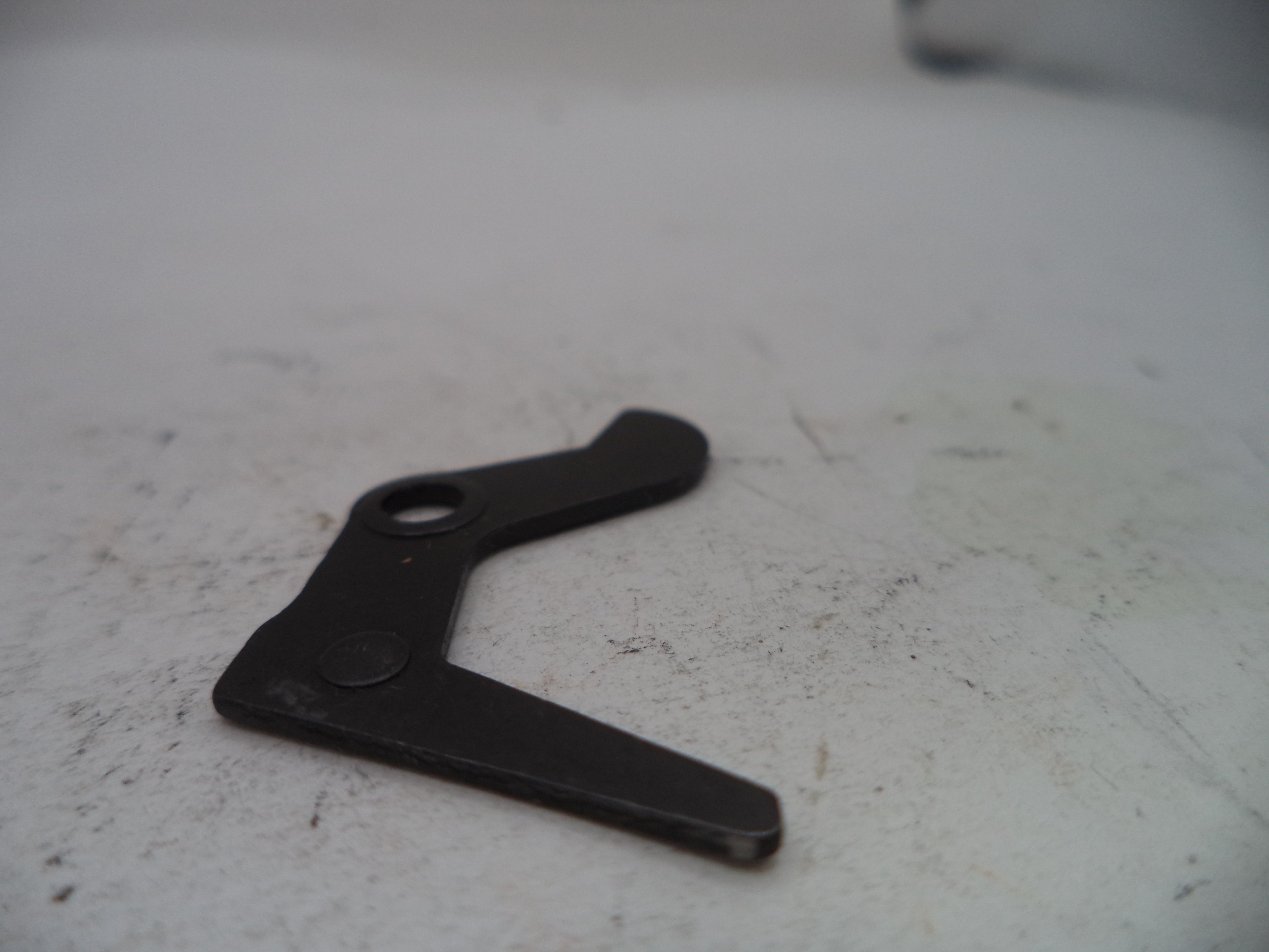 Black metal bracket on a white surface