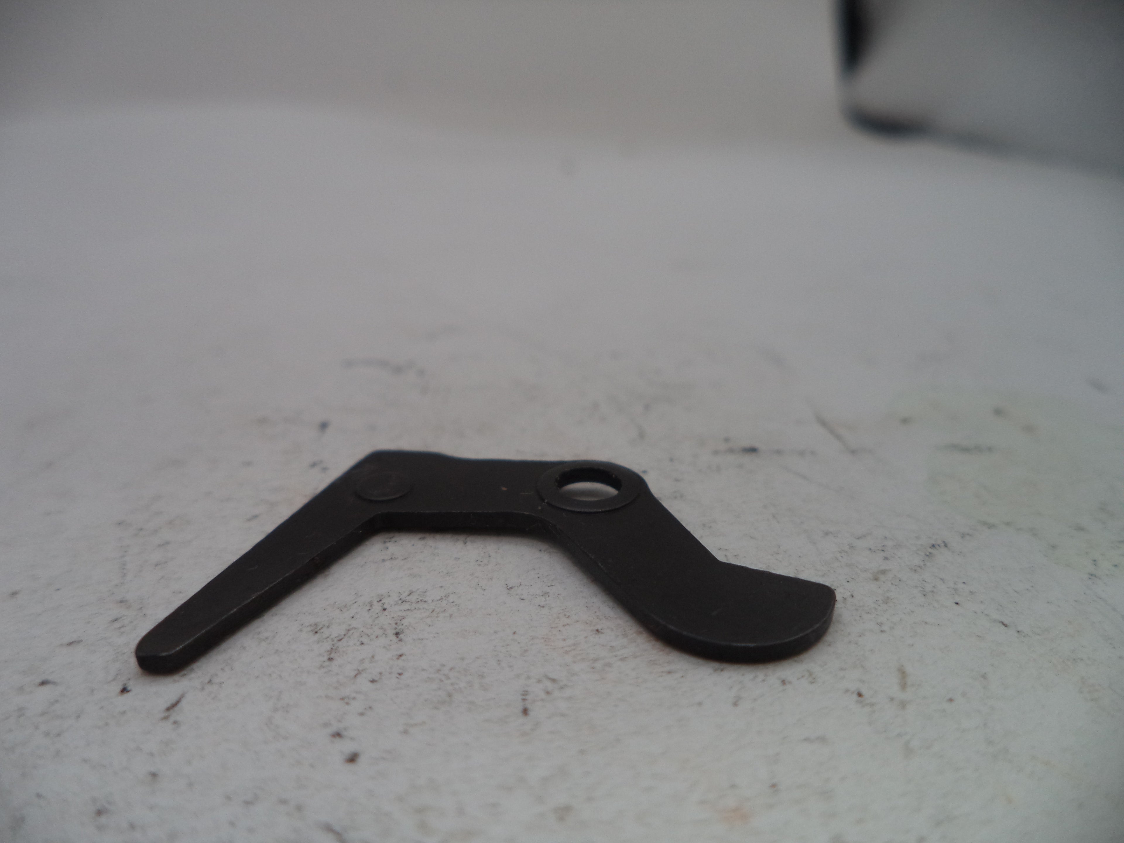 Black metal tool on a white surface