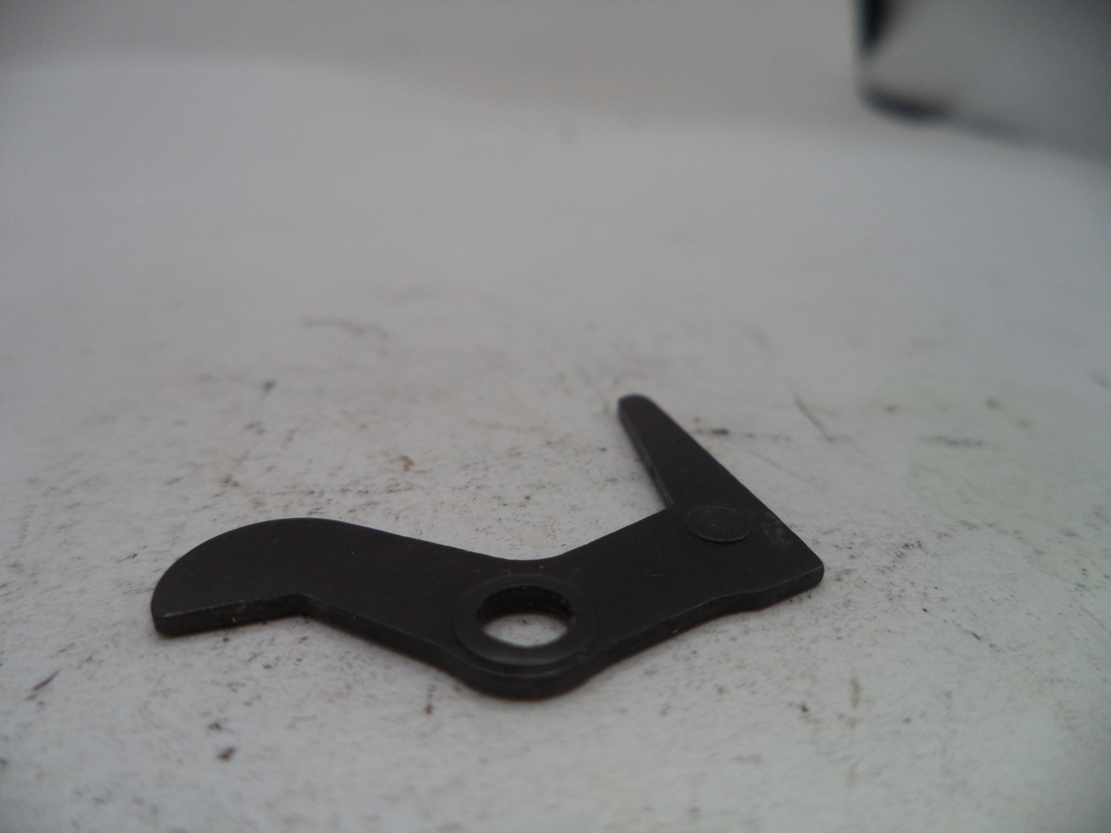 Black metal lever on a textured white surface