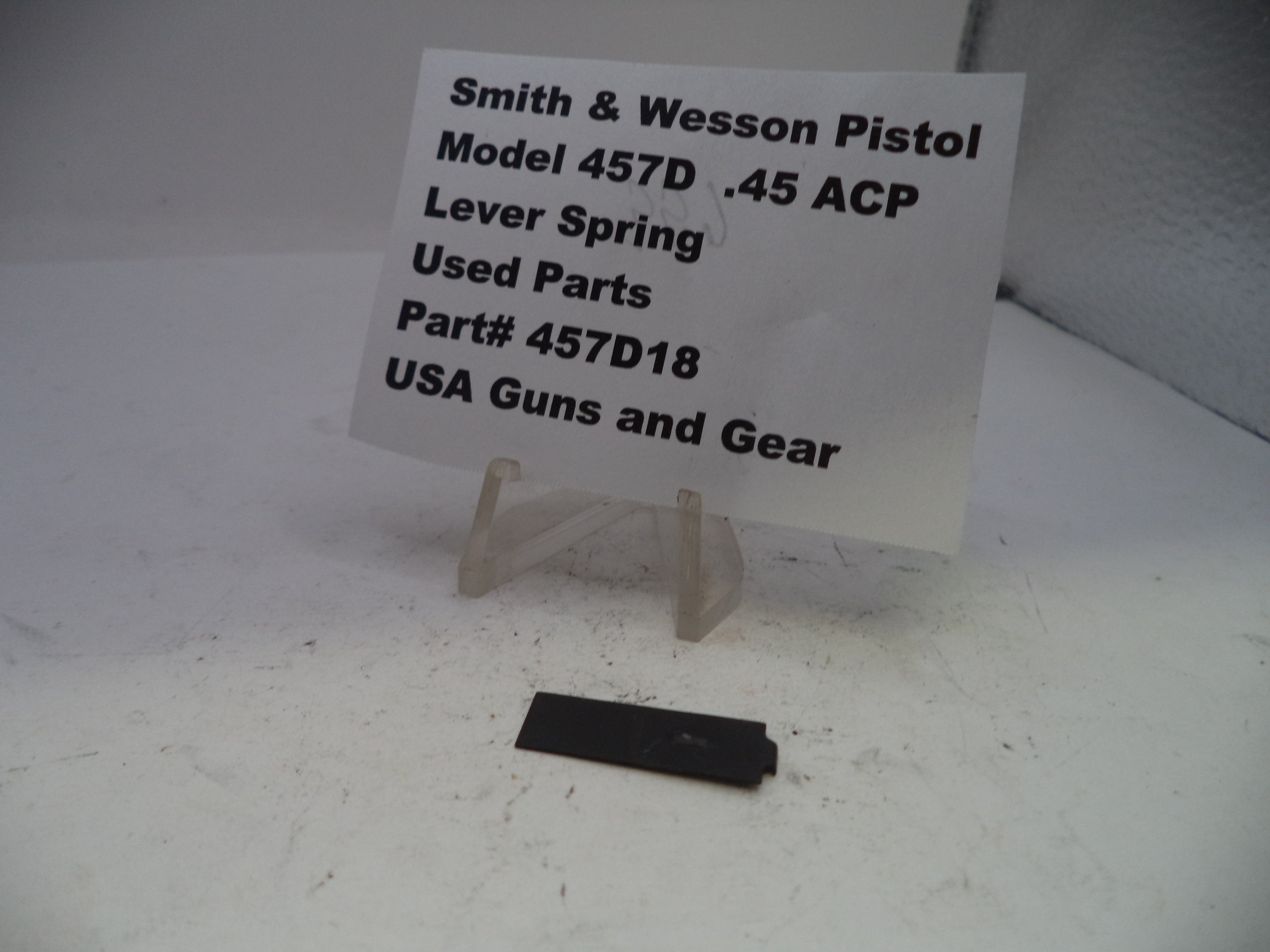 Smith & Wesson pistol lever spring with a sign on a white background