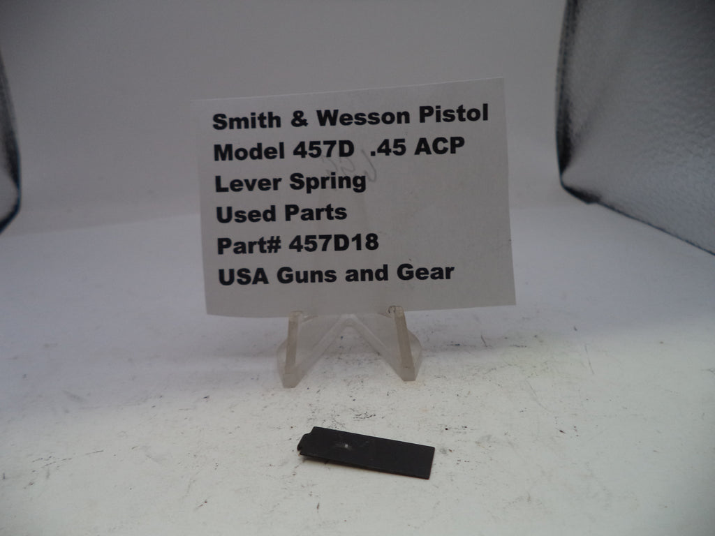 Smith & Wesson pistol part with descriptive card on a white background