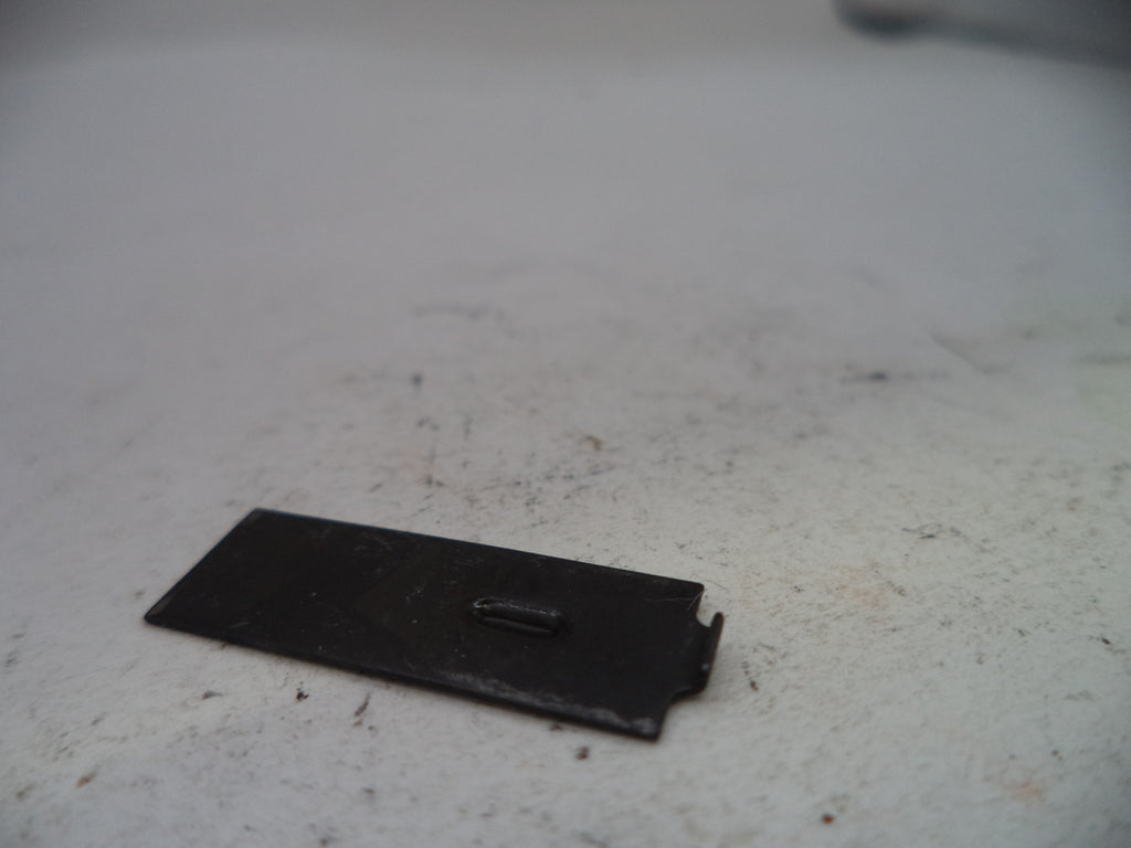 Small black rectangular object on a textured white surface