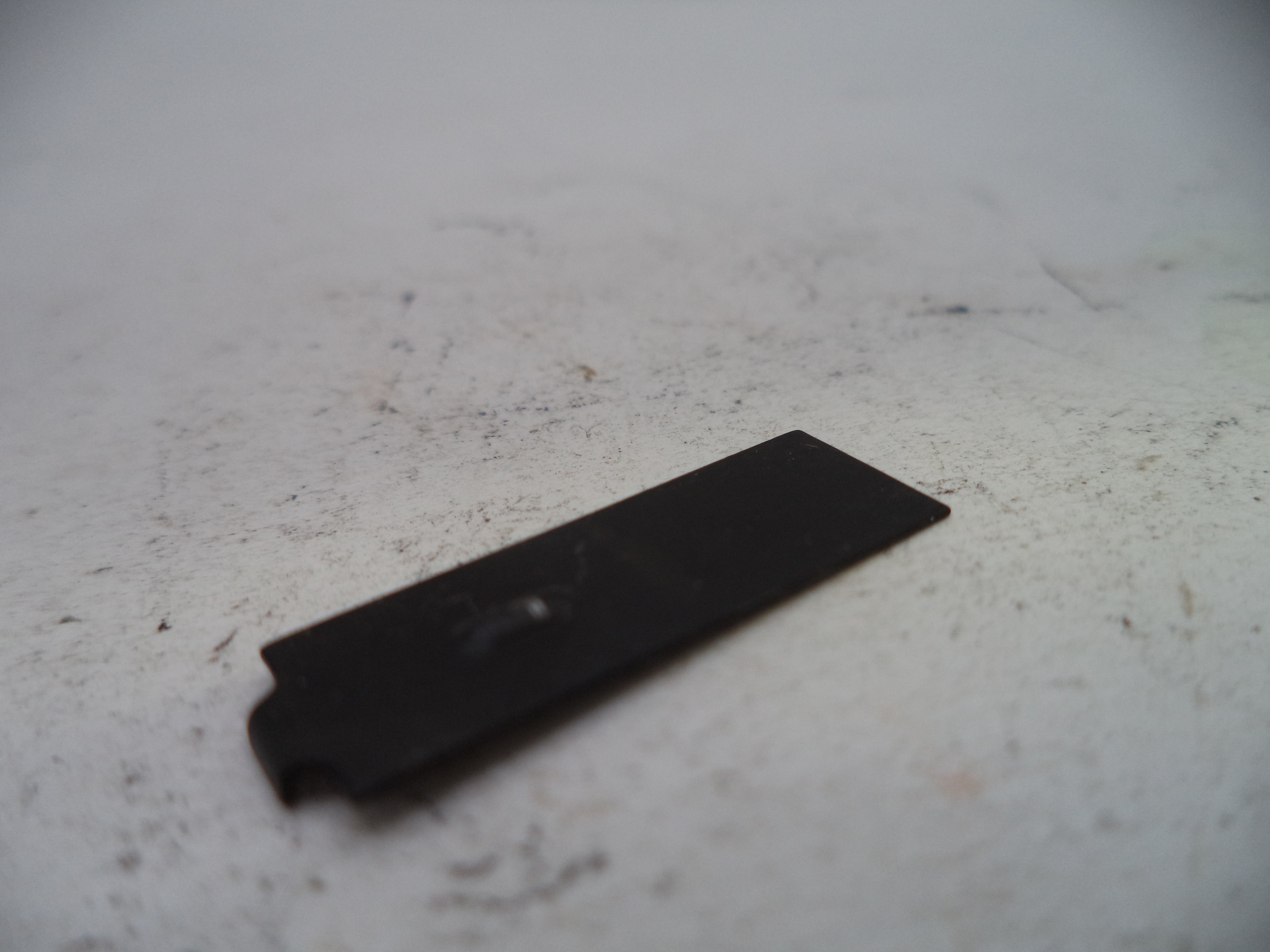 Black rectangular object on a light-colored surface