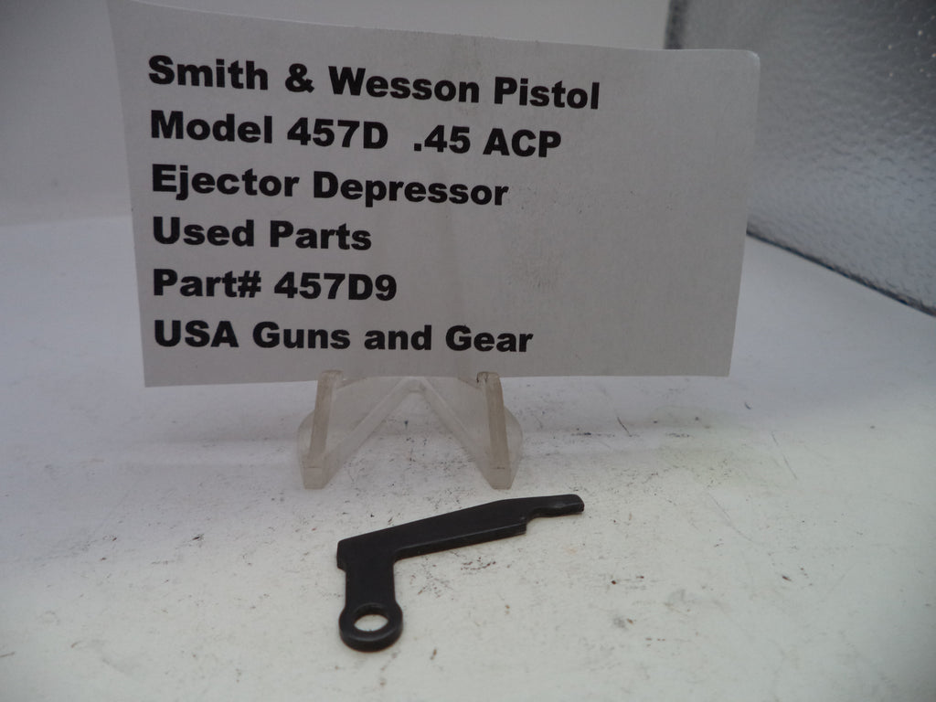 Smith & Wesson pistol part on a white surface with a label